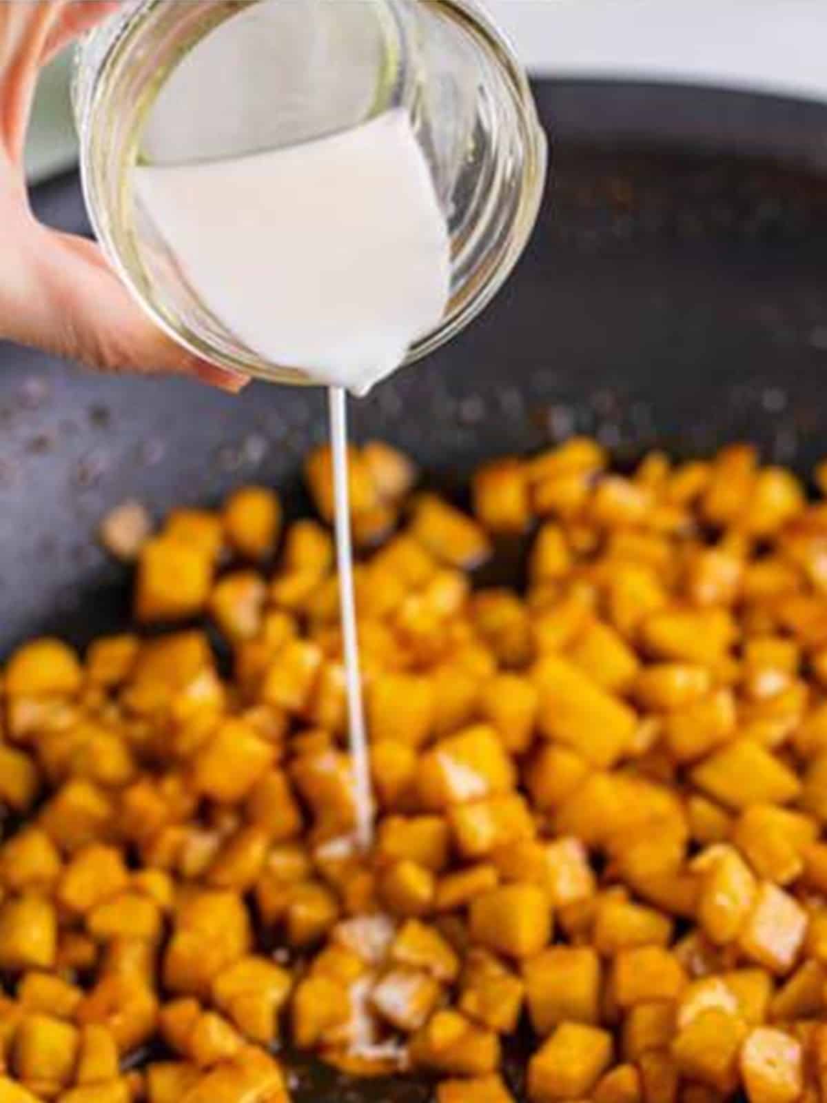Cornstarch slurry streamed into the simmering apple filling to thicken it.