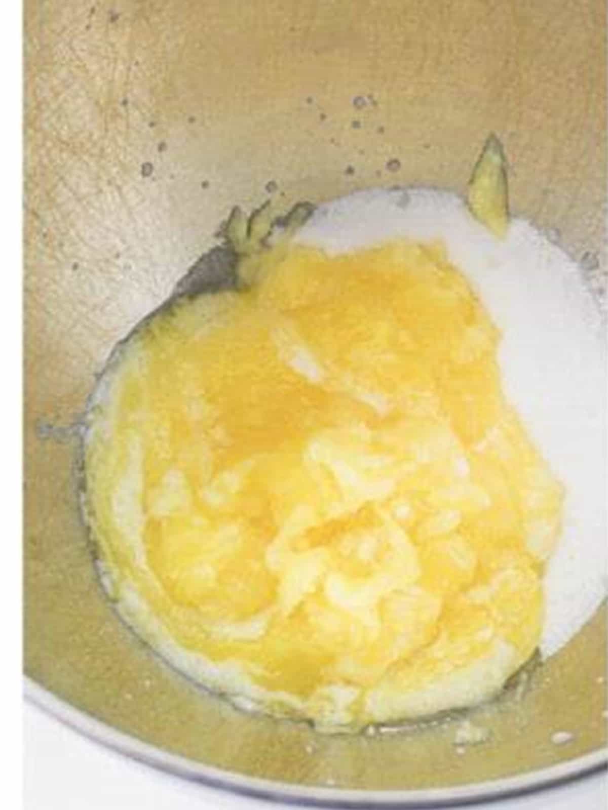 Butter and sugar creamed together in a stand mixer bowl.