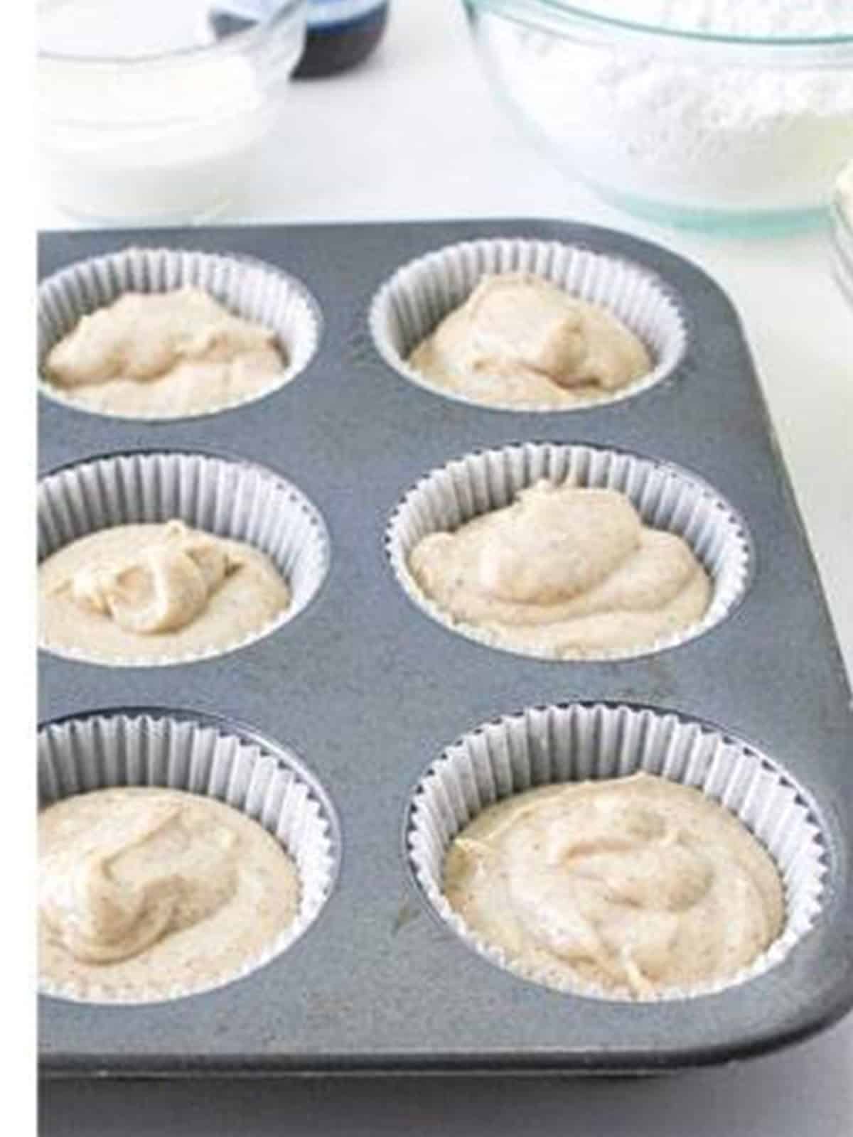 Apple Pie Cupcakes batter portioned into a lined muffin tin.