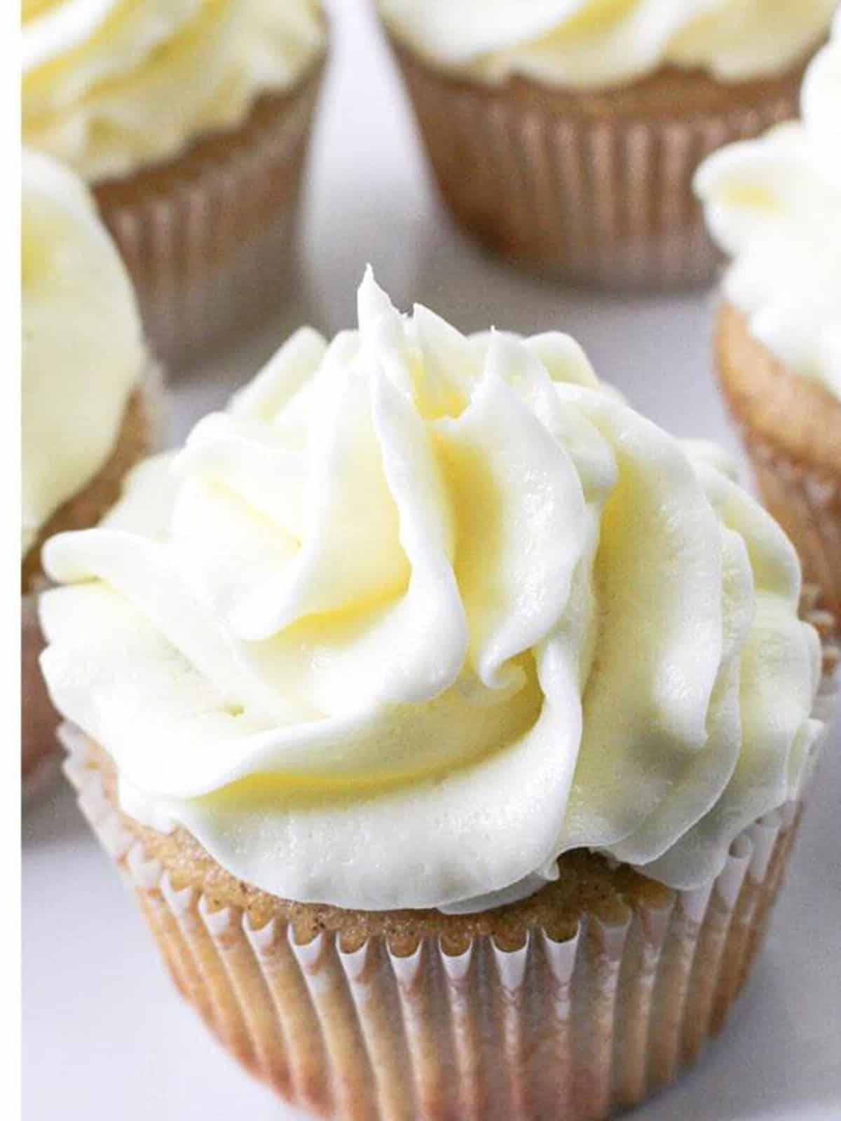 An Apple Pie Cupcake topped with swirled vanilla buttercream frosting.