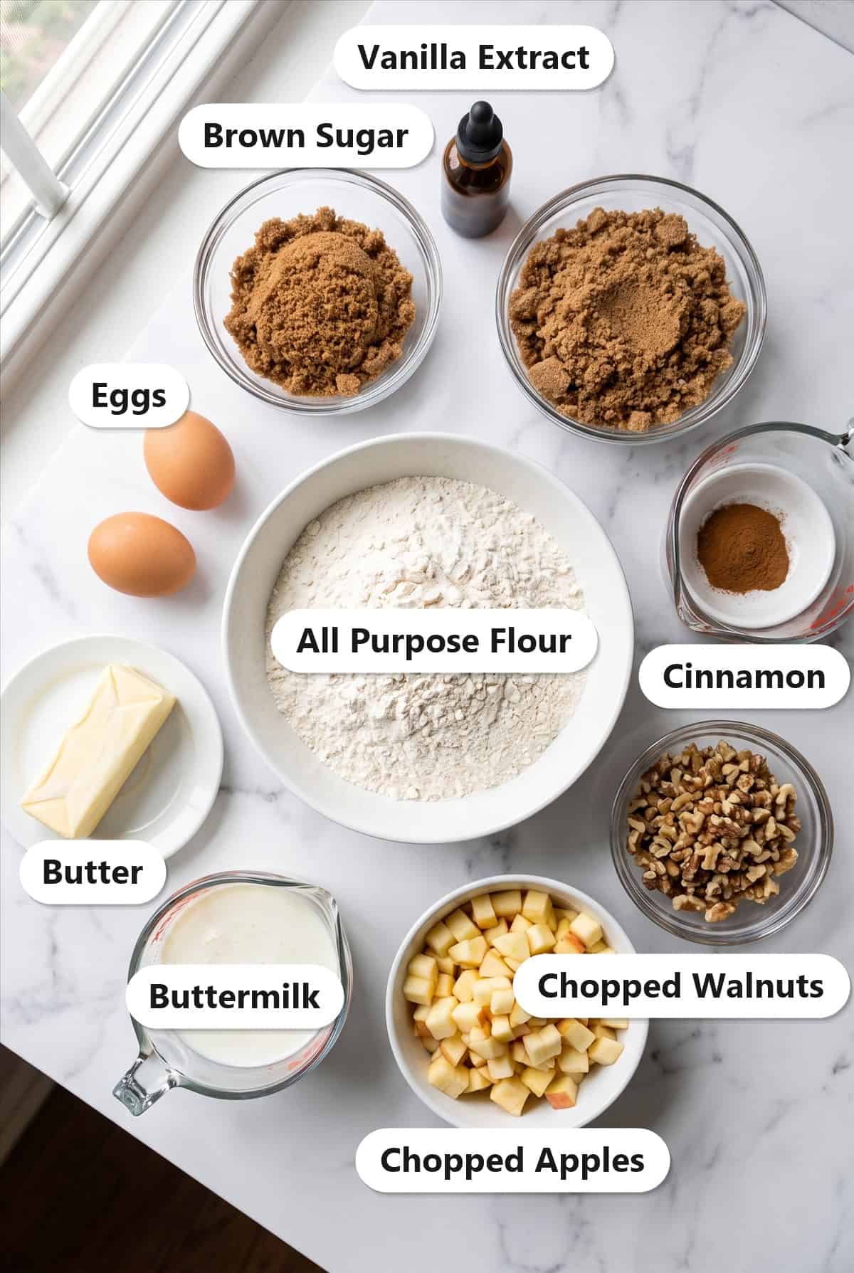 Labeled ingredients for apple walnut bread: flour, brown sugar, eggs, butter, buttermilk, chopped apples, chopped walnuts, cinnamon, and vanilla extract.