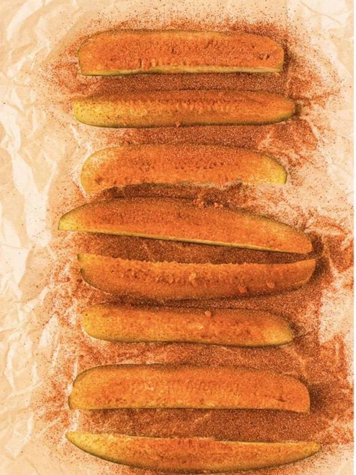 Dill pickle spears patted dry and sprinkled with a smoked paprika seasoning blend.