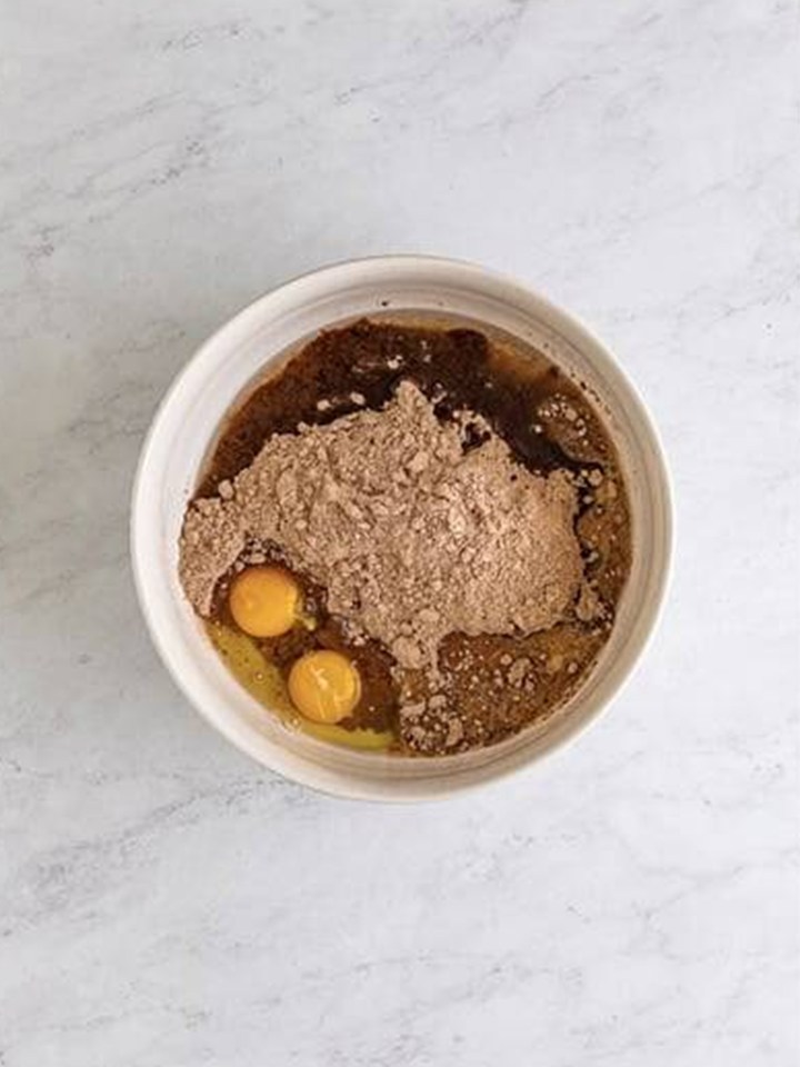 Fudge brownie mix, eggs, Baileys, and oil in a mixing bowl for baileys brownies.