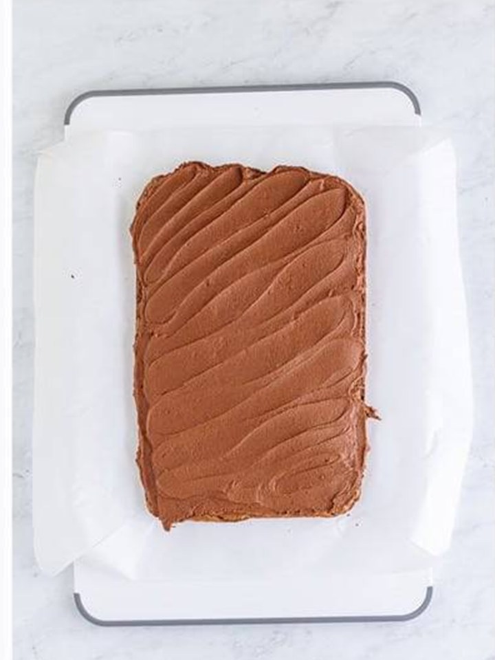 Whipped Baileys ganache spread in an even layer over the brownie slab.