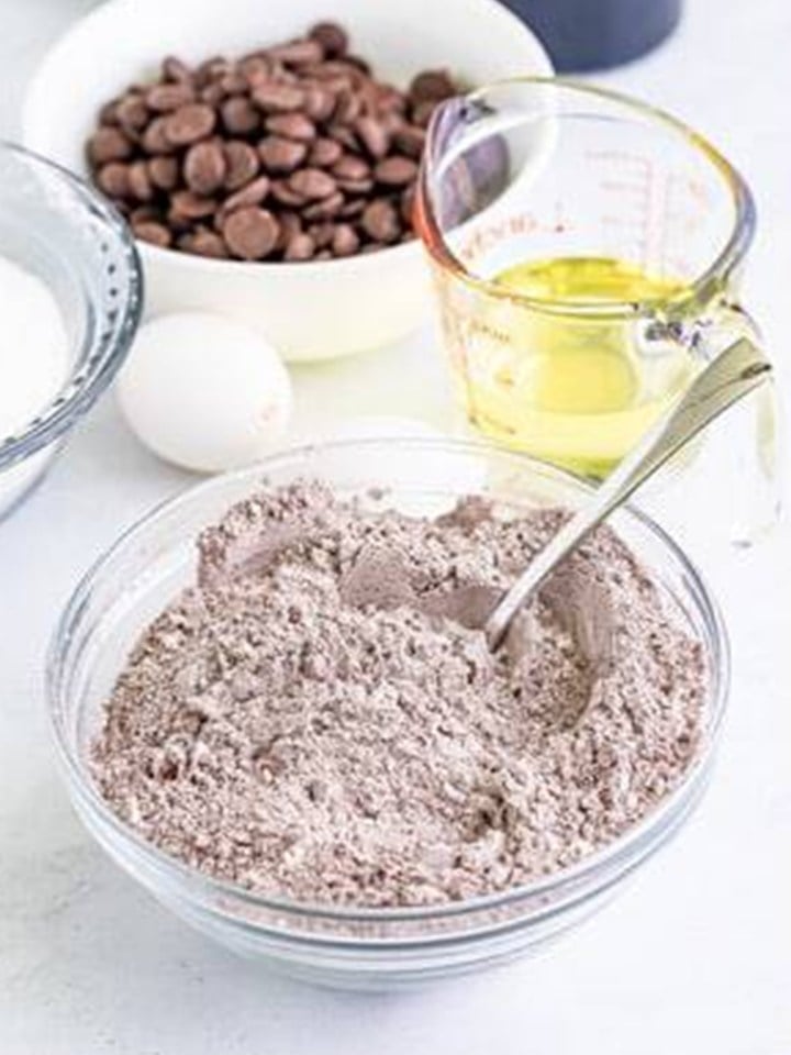 Flour, cocoa powder, baking powder, and salt stirred together for baileys cupcakes.