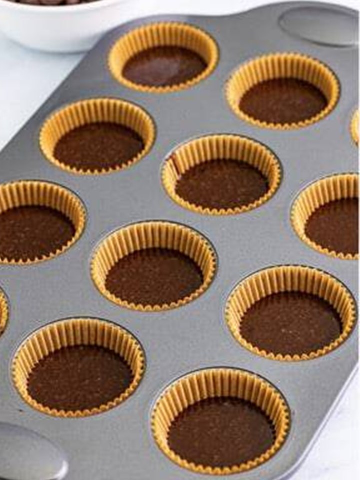 Baileys cupcake batter portioned into a lined muffin tin.