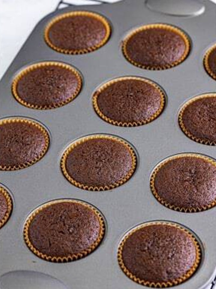 Baked baileys cupcakes cooling in the muffin tin.