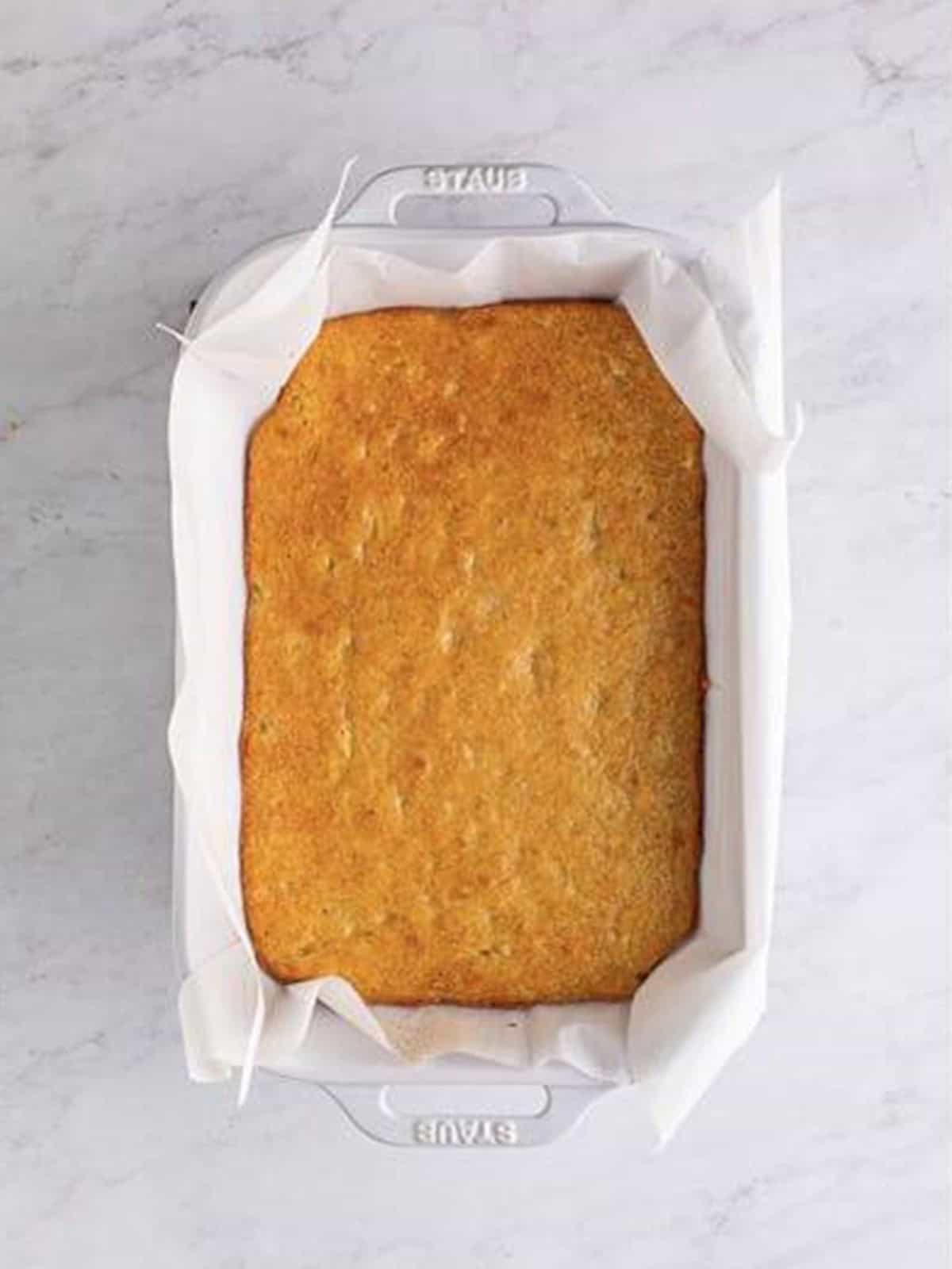 Baked Banana Blondies with golden brown edges cooling in the baking dish.