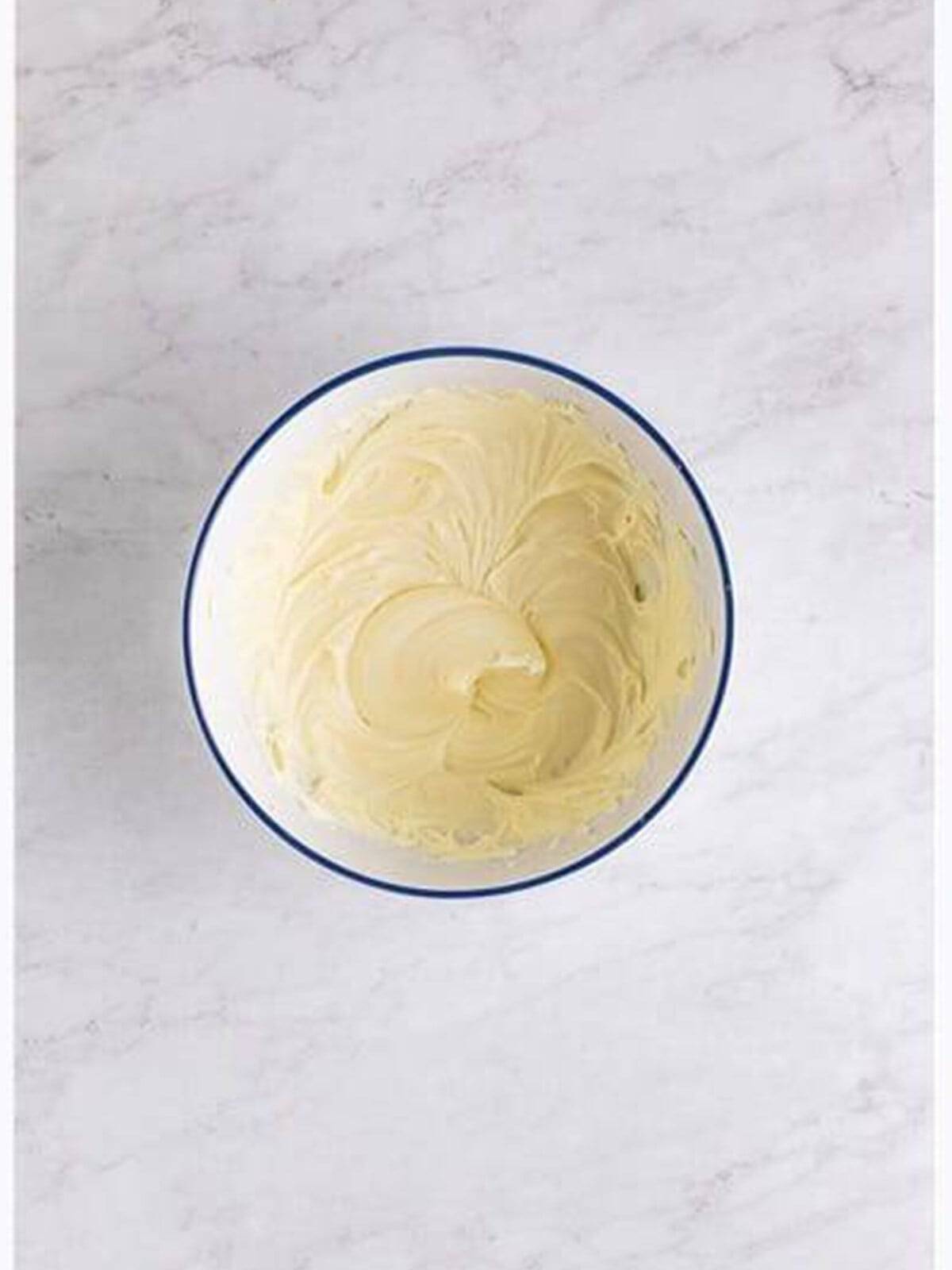Whipped cream cheese frosting in a bowl for Banana Blondies.
