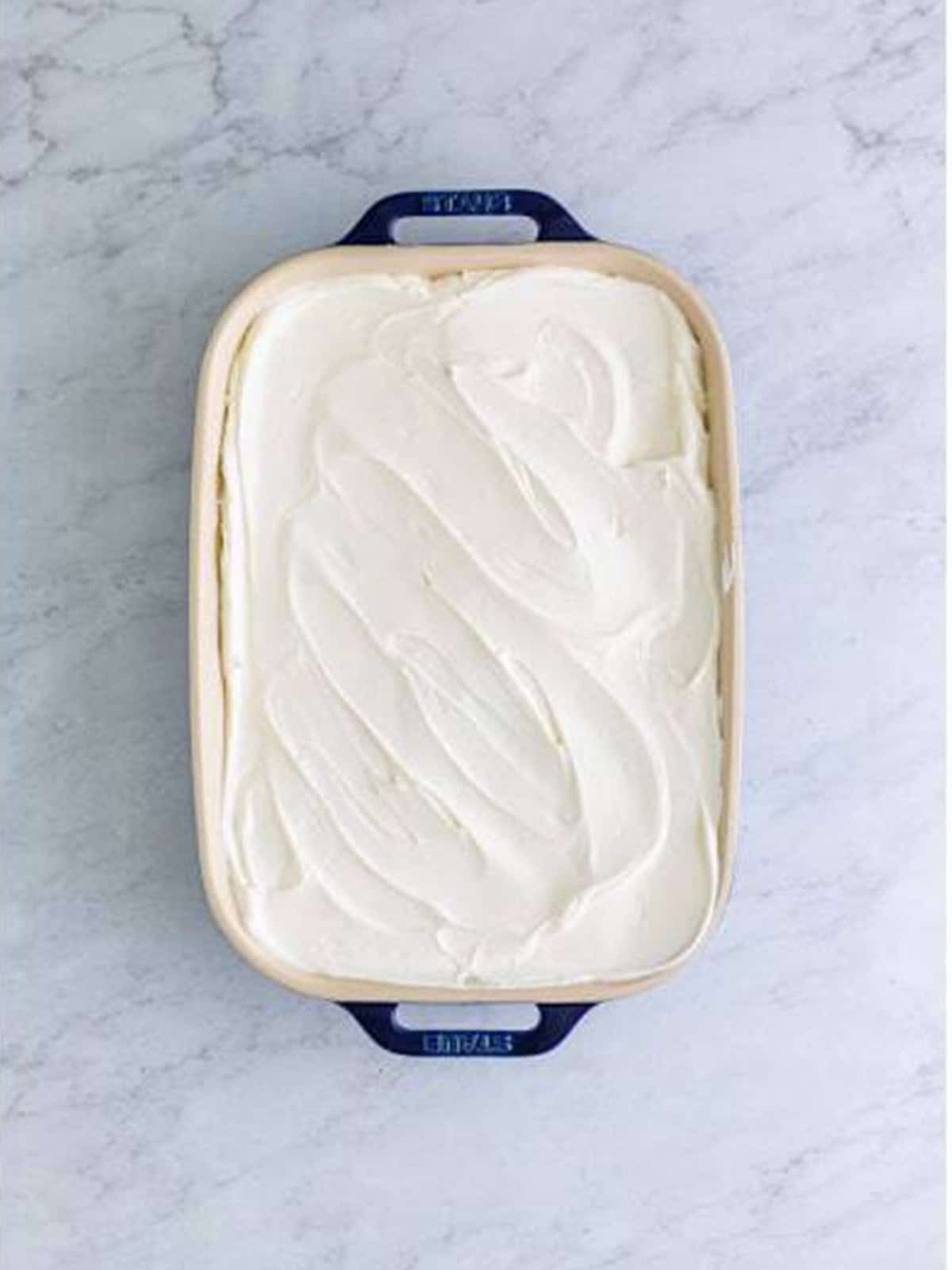Whipped topping smoothed over the top layer of the banana icebox cake.