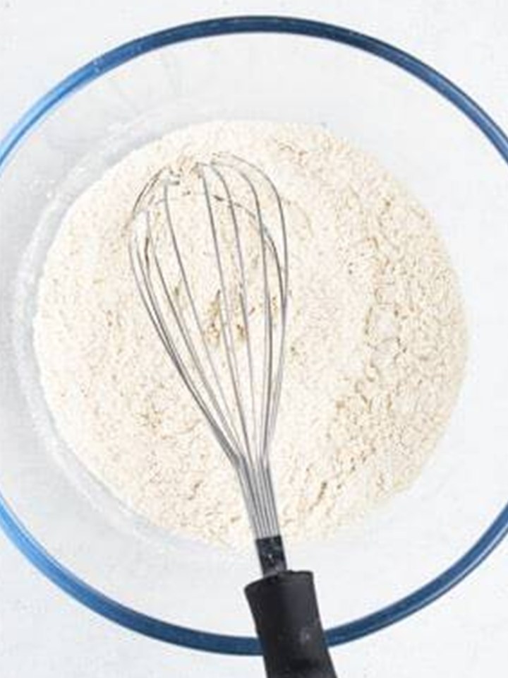 Flour, cinnamon, salt, and leavening whisked together in a glass bowl.