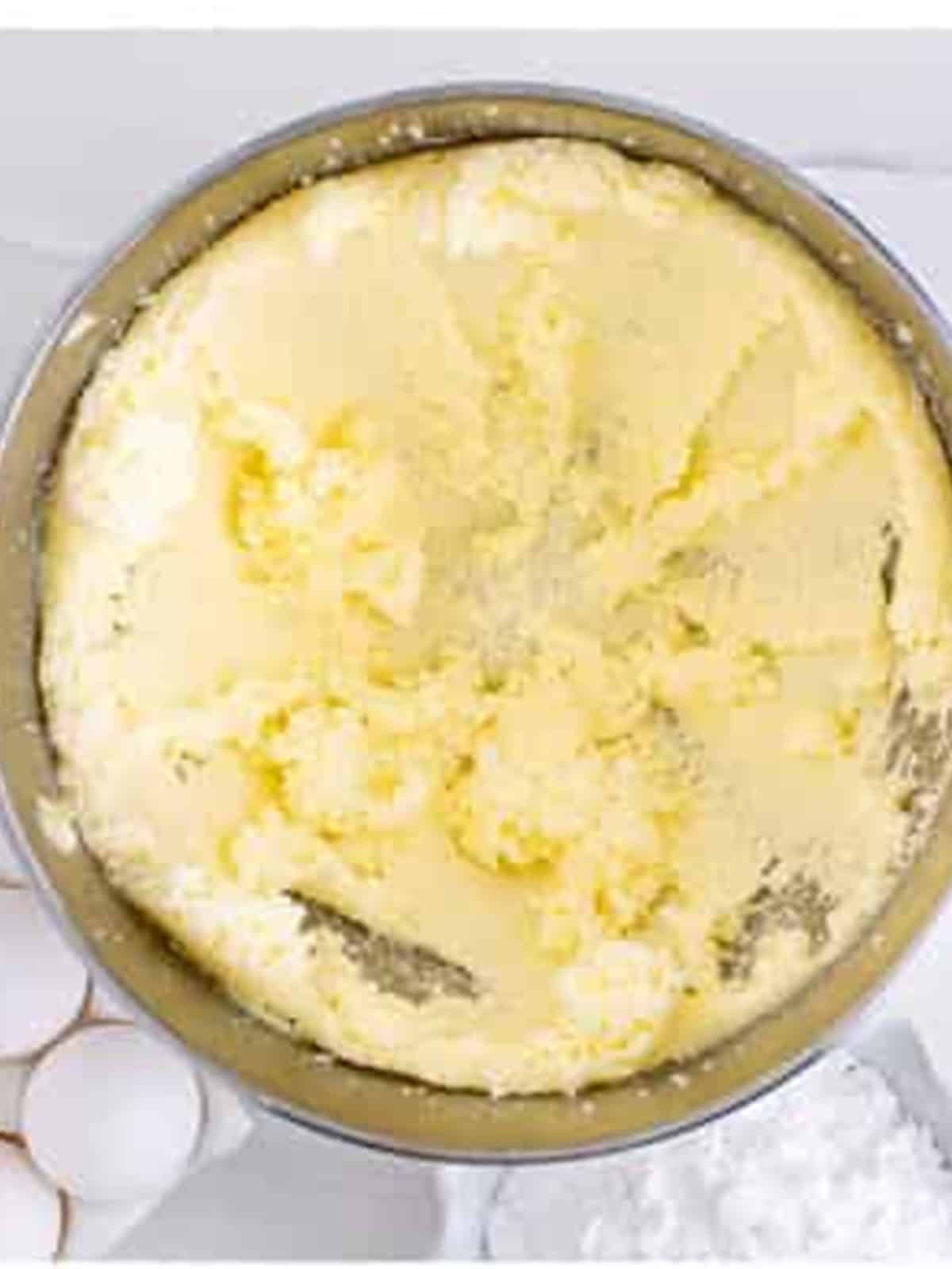 Butter and sugar creamed together until fluffy in a stand mixer bowl for blueberry bars.