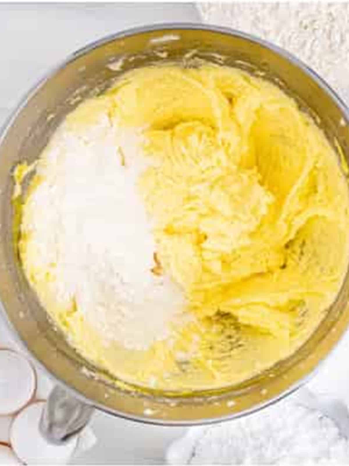 Flour added to the creamed butter, sugar, eggs, and extracts for blueberry bar dough.