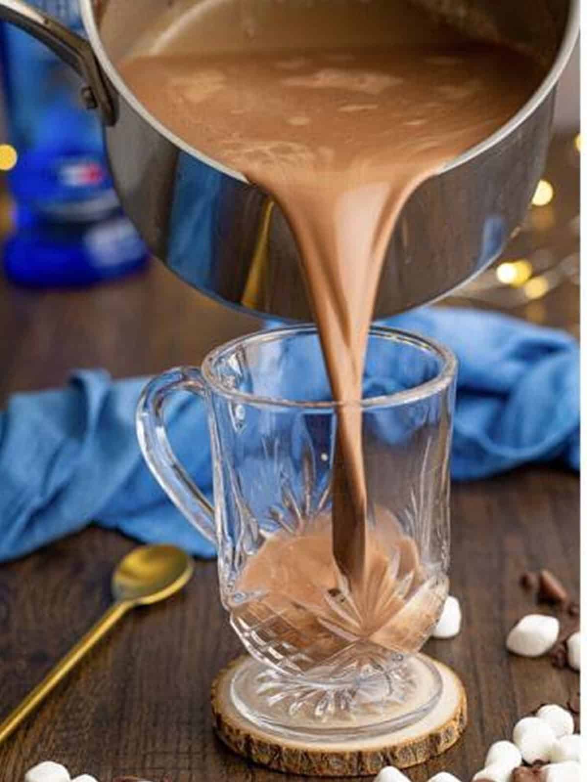 Rich hot chocolate being poured into the mug over the vodka.