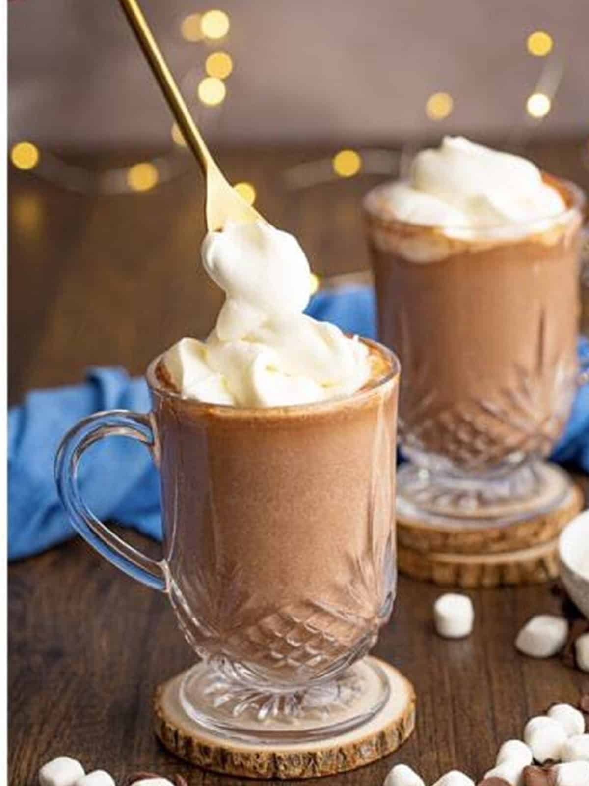 Boozy hot chocolate topped with whipped cream and mini marshmallows.
