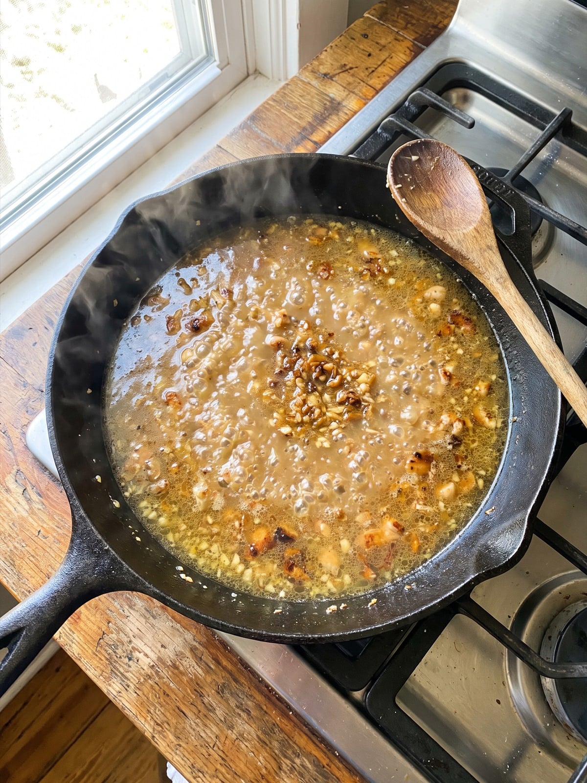 Garlic and chicken stock deglazing the skillet.