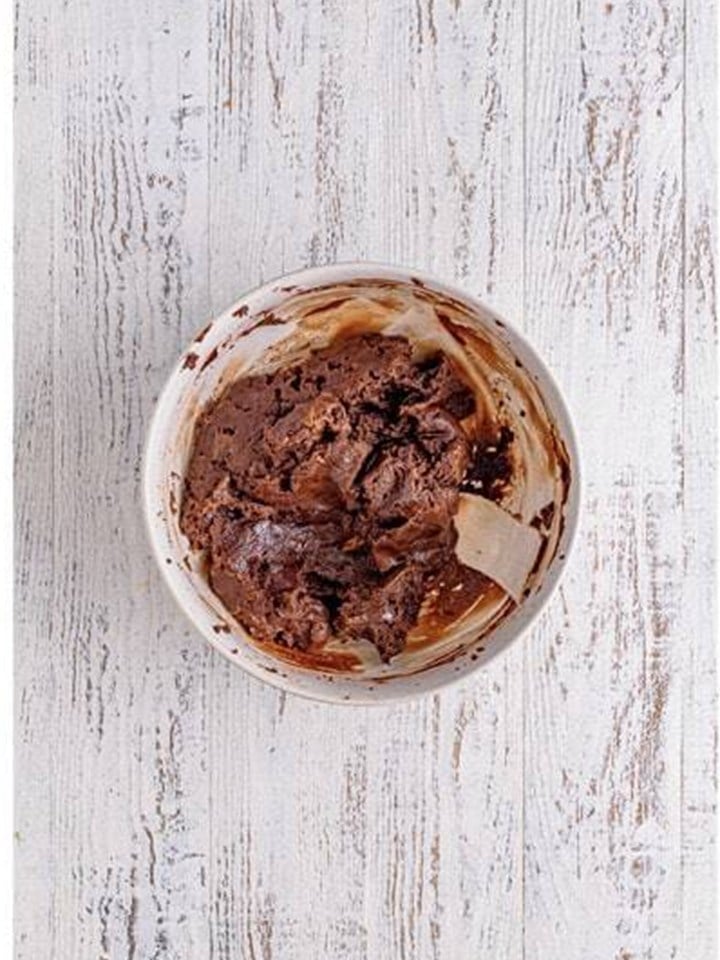 The brownie and cream cheese mixture mixed smooth for rolling brownie truffles.