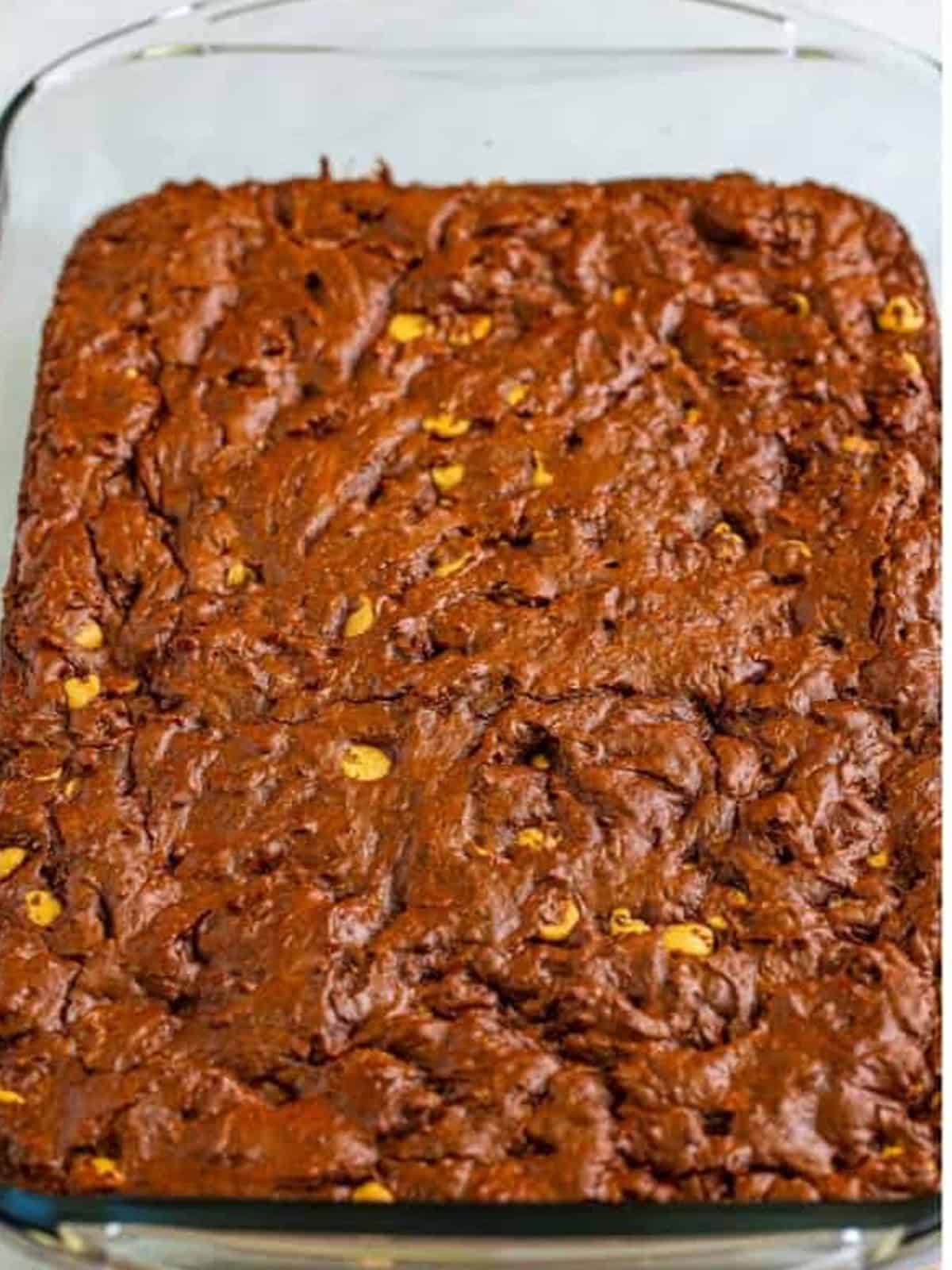 Baked Butterfinger brownies fresh out of the oven in a glass baking dish.
