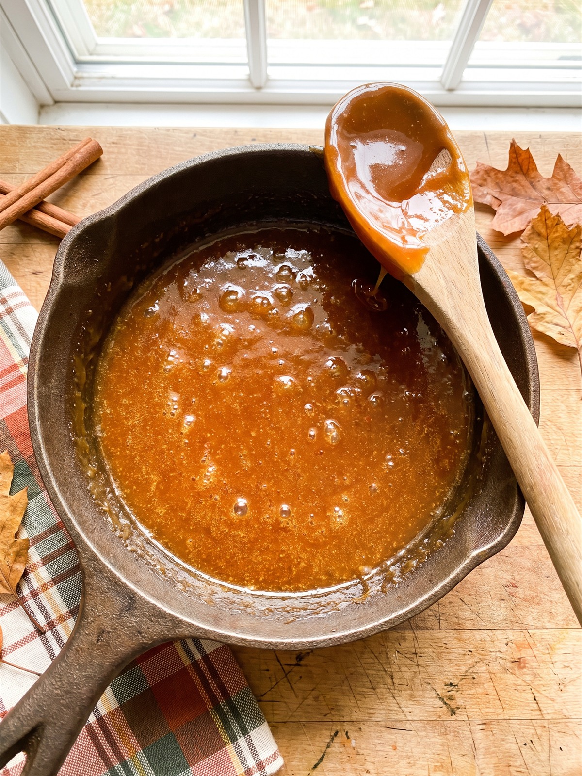 Thick golden caramel pudding cooked in a saucepan.