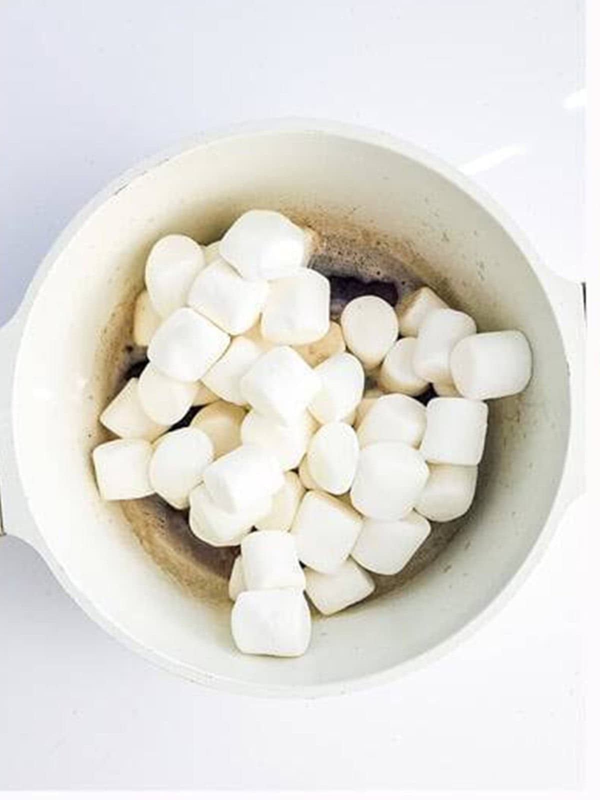 Jumbo marshmallows added to the browned butter in the pot.