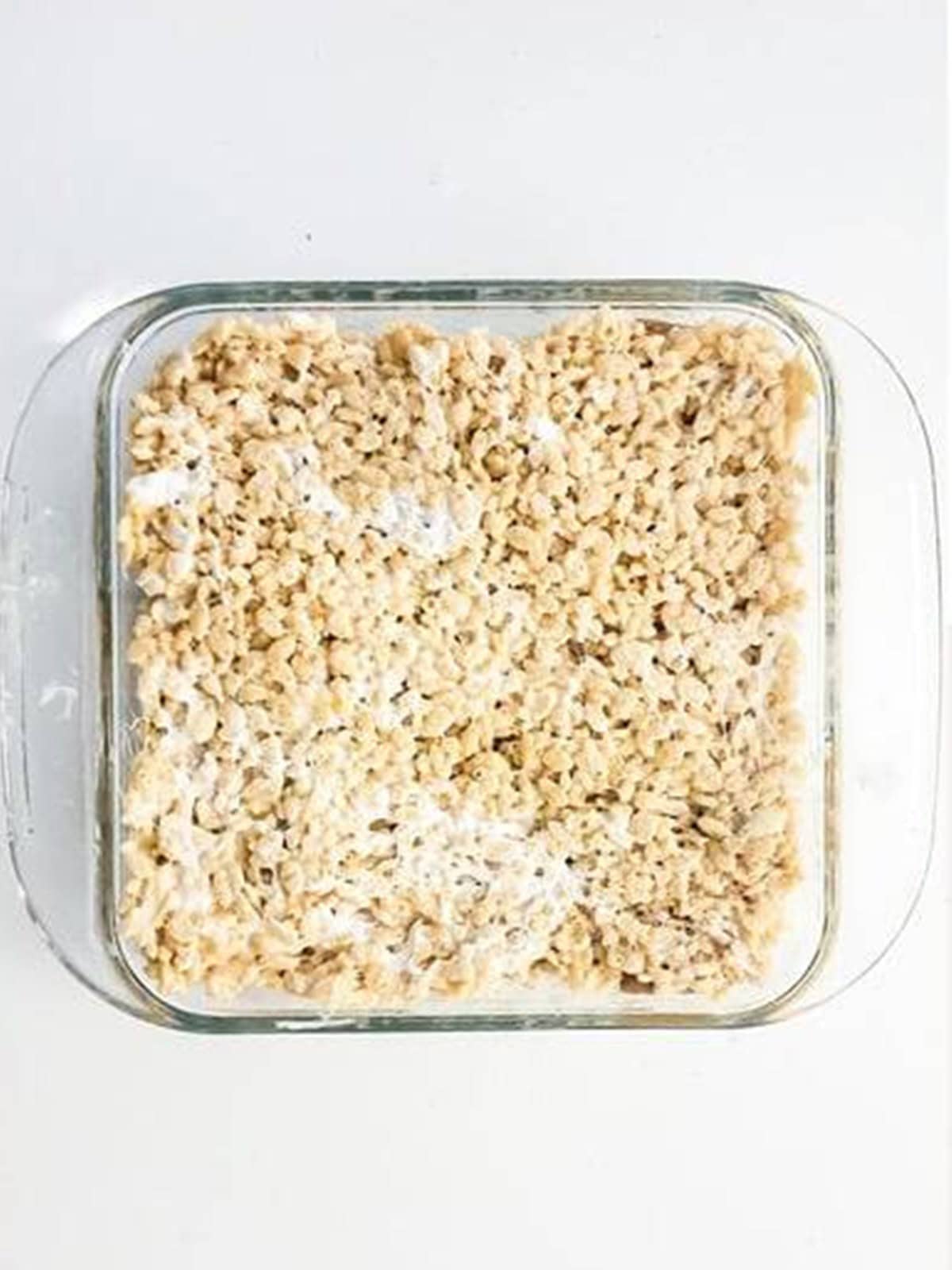 The second layer of rice krispie mixture pressed over the dulce de leche.