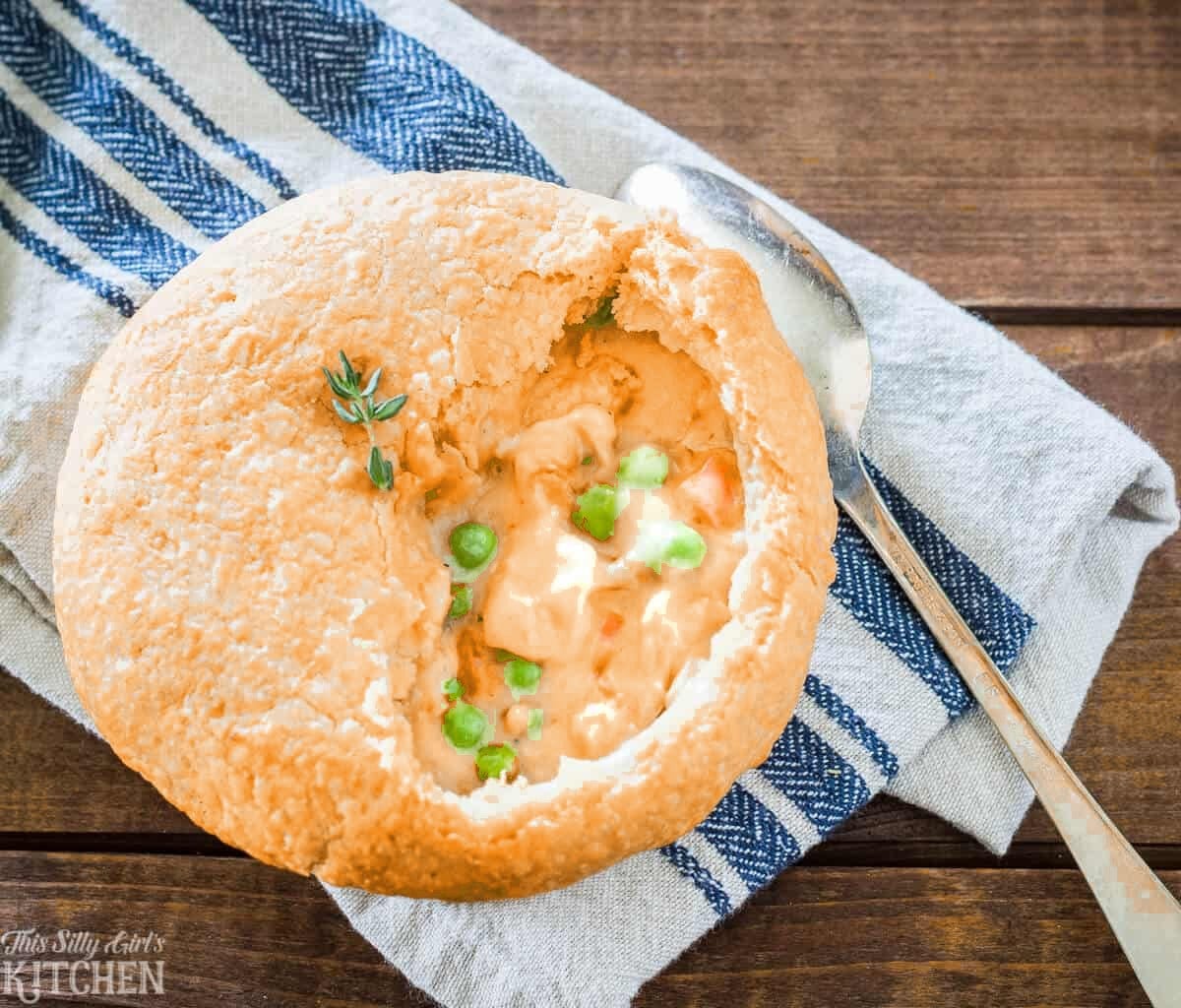 A Chedz cheesy chicken pot pie broken open to show the creamy chicken and vegetable filling.