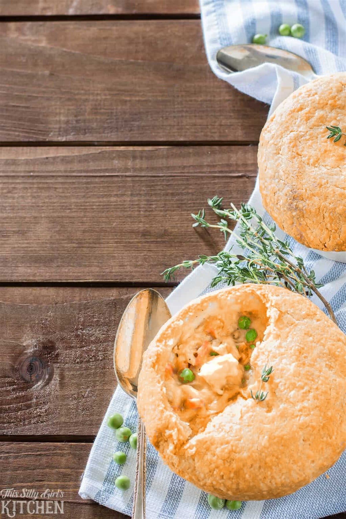Two Chedz cheesy chicken pot pies with golden cheddar crusts and fresh thyme.