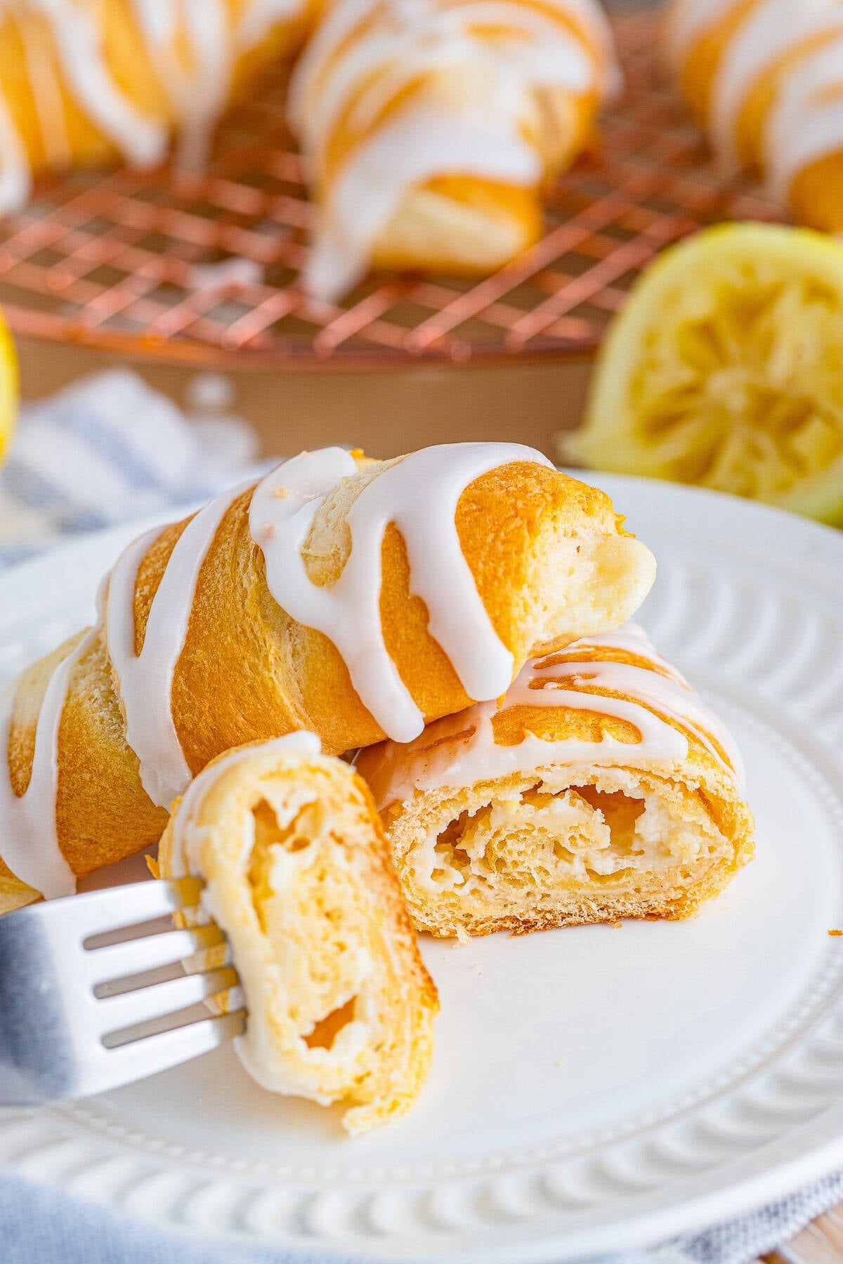 A Cheesecake Crescent Roll cut open to show the creamy lemon cheesecake filling inside.