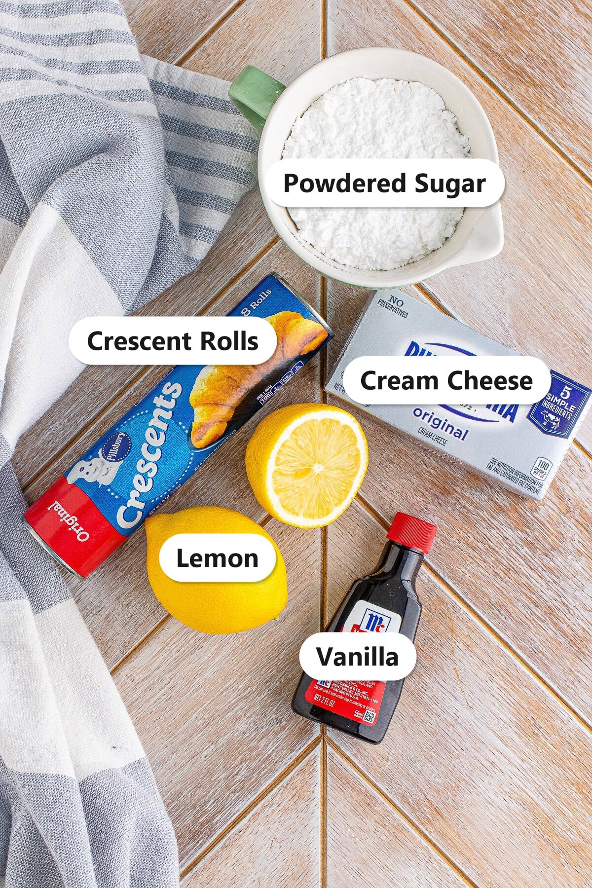 Labeled ingredients for Cheesecake Crescent Rolls including crescent rolls, cream cheese, powdered sugar, lemon, and vanilla.