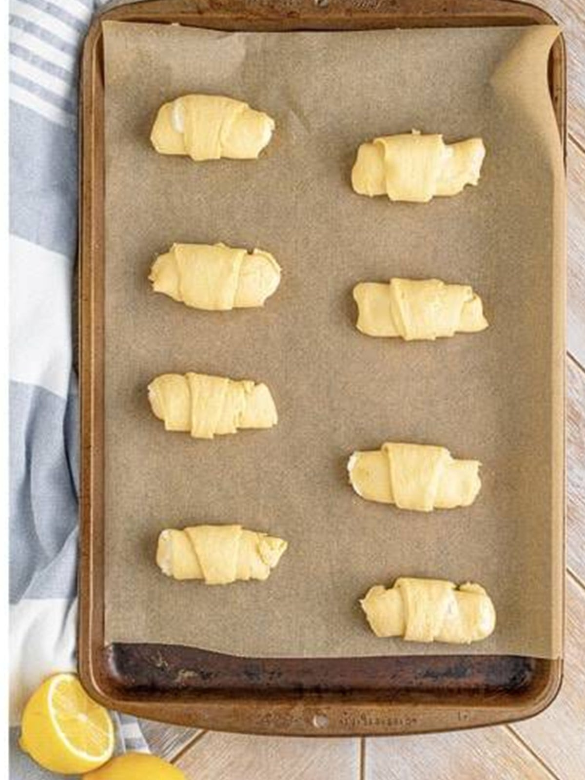 Golden baked Cheesecake Crescent Rolls fresh out of the oven on a baking sheet.