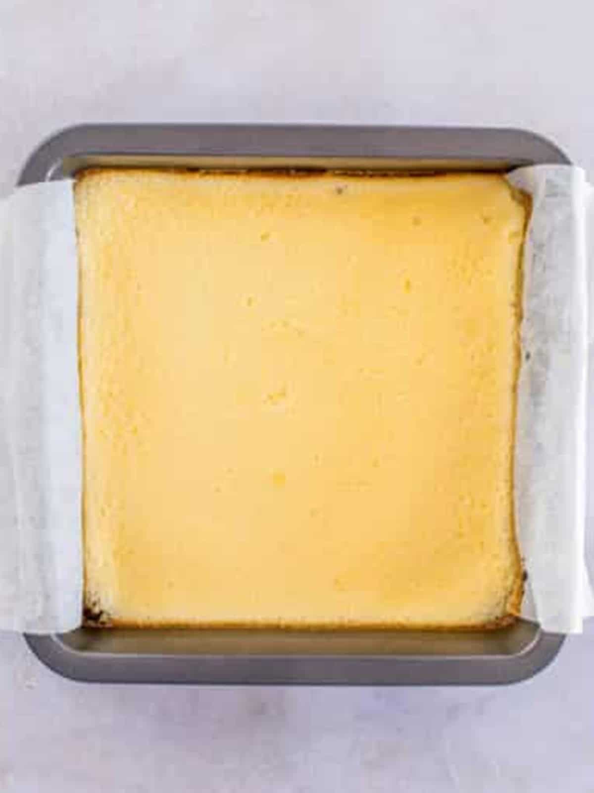 Baked cheesecake layer set over the Oreo crust in the pan.
