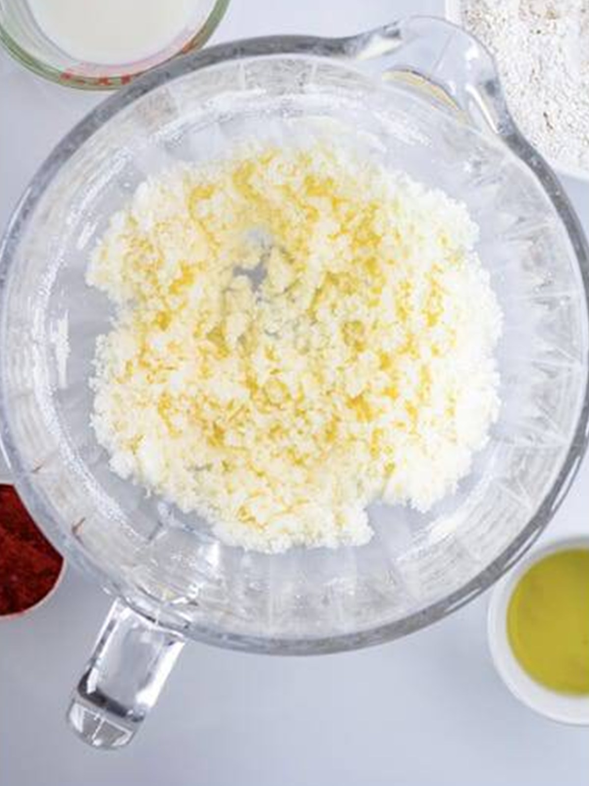 Butter cut into the sugar in a glass mixing bowl for cherry cupcake batter.