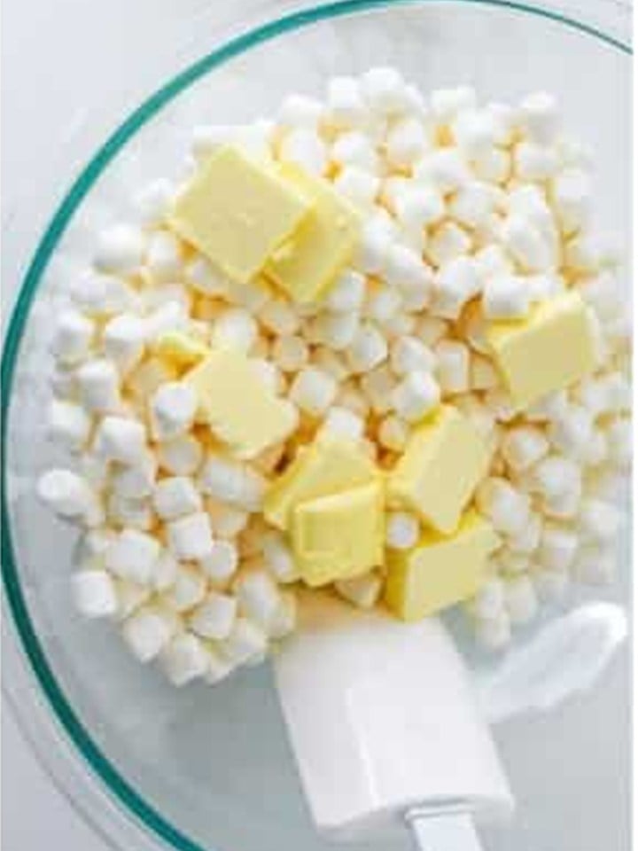 Mini marshmallows and butter in a glass bowl ready to melt for chex bars.