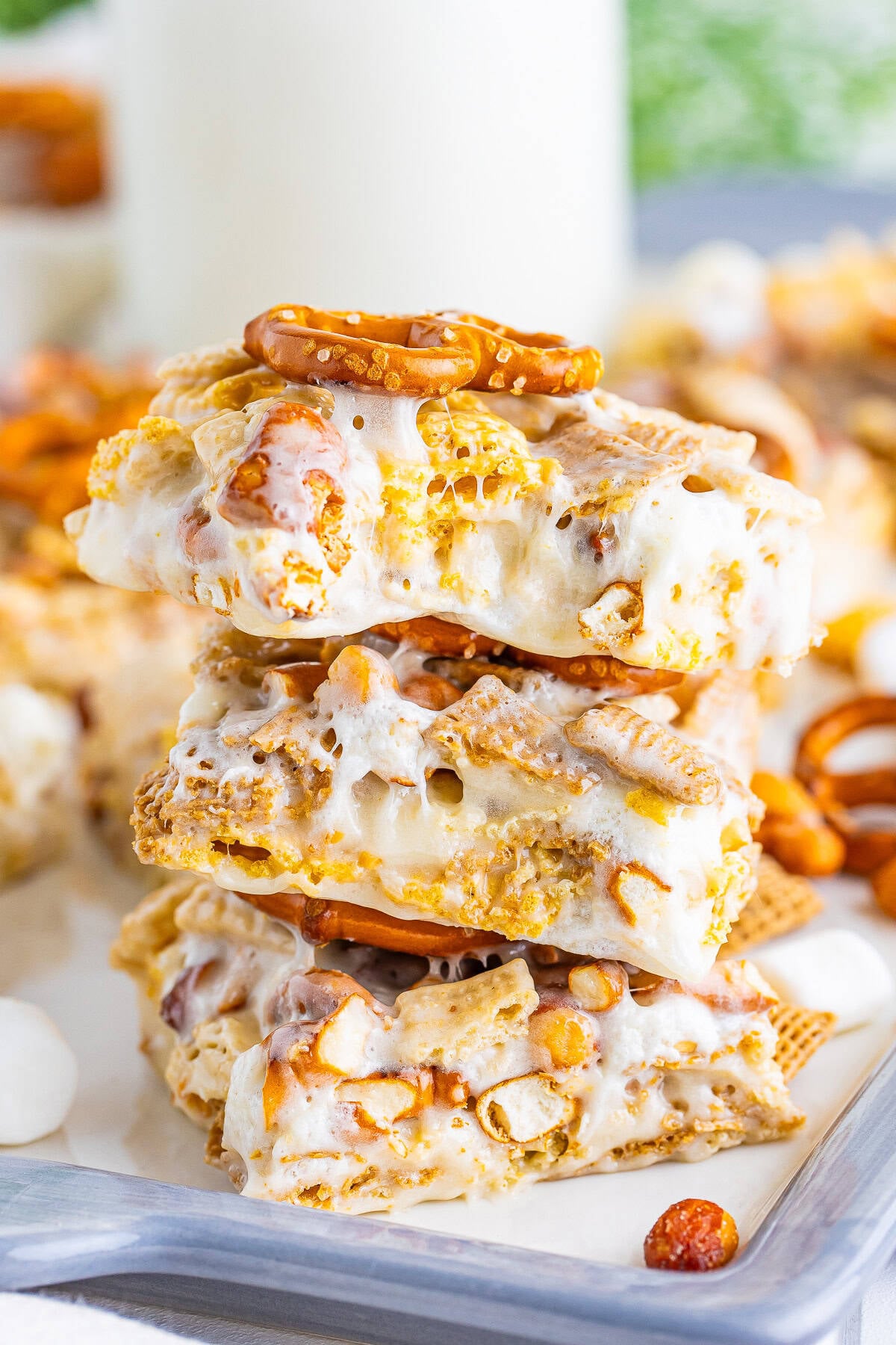 A stack of Chex Marshmallow Treats showing the gooey marshmallow, cereal, pretzels, and nuts inside.