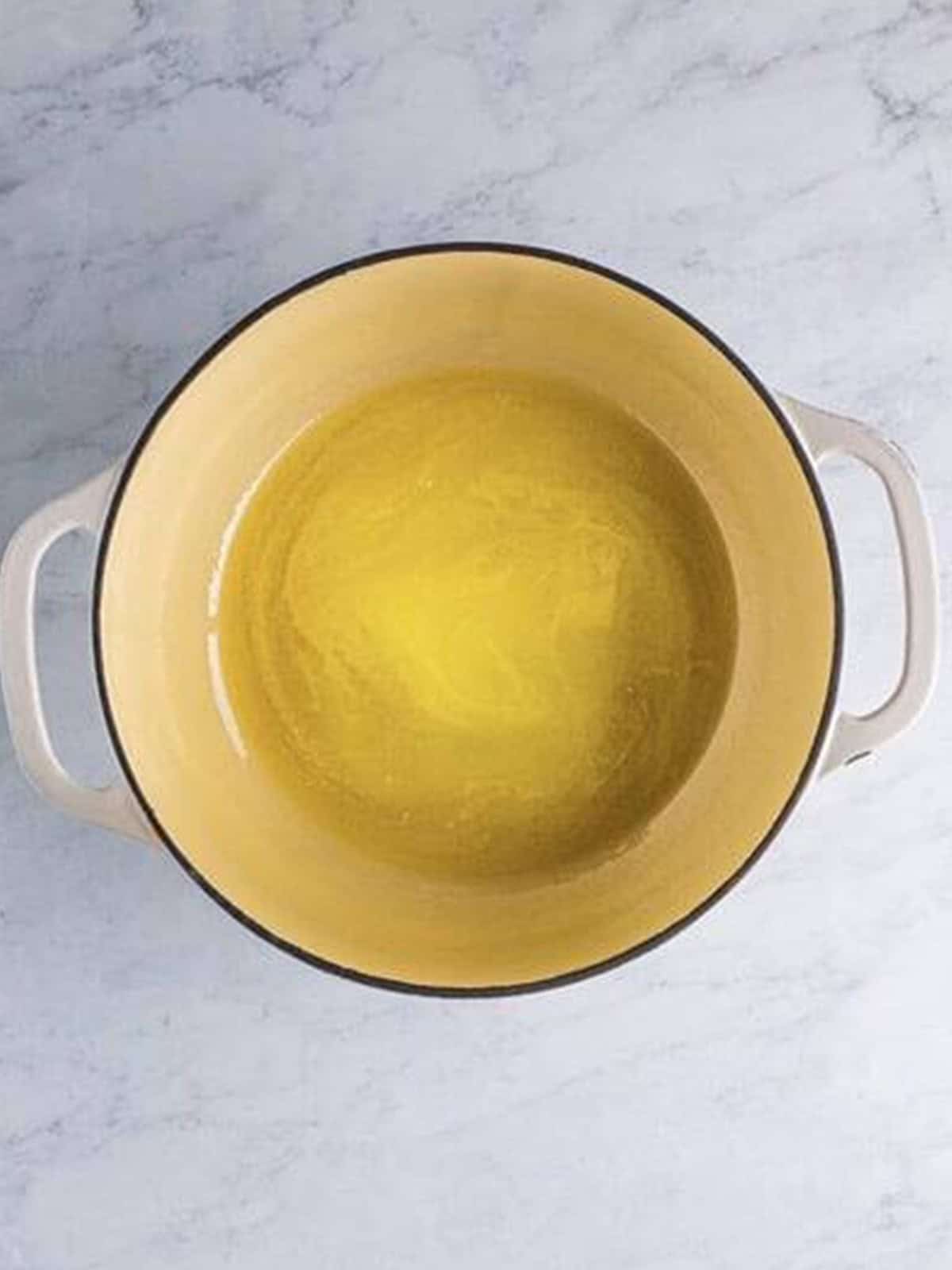 Melting butter in a large pot to start the Chex Marshmallow Treats.