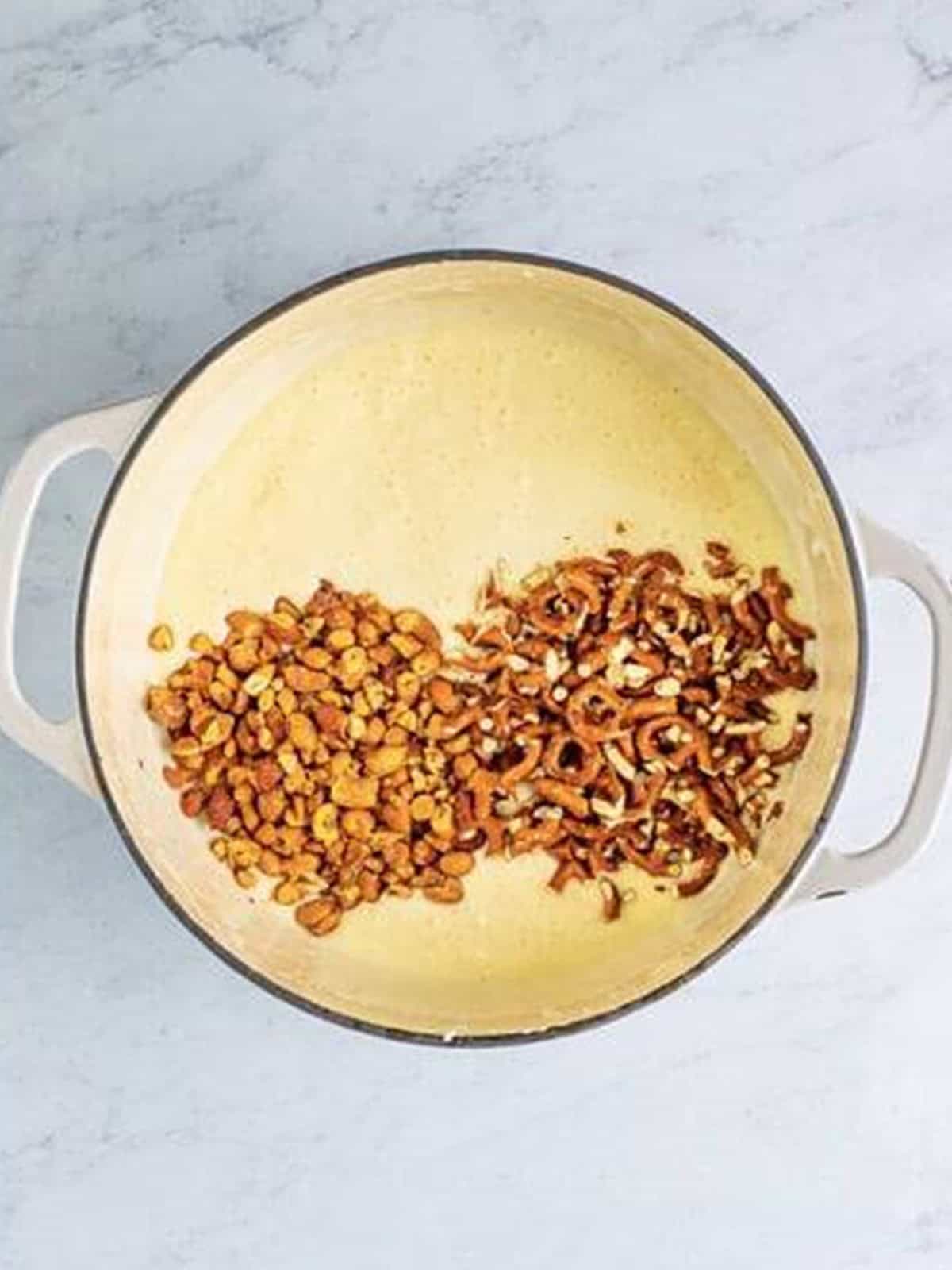 Mini marshmallows melted smooth into the butter for Chex Marshmallow Treats.