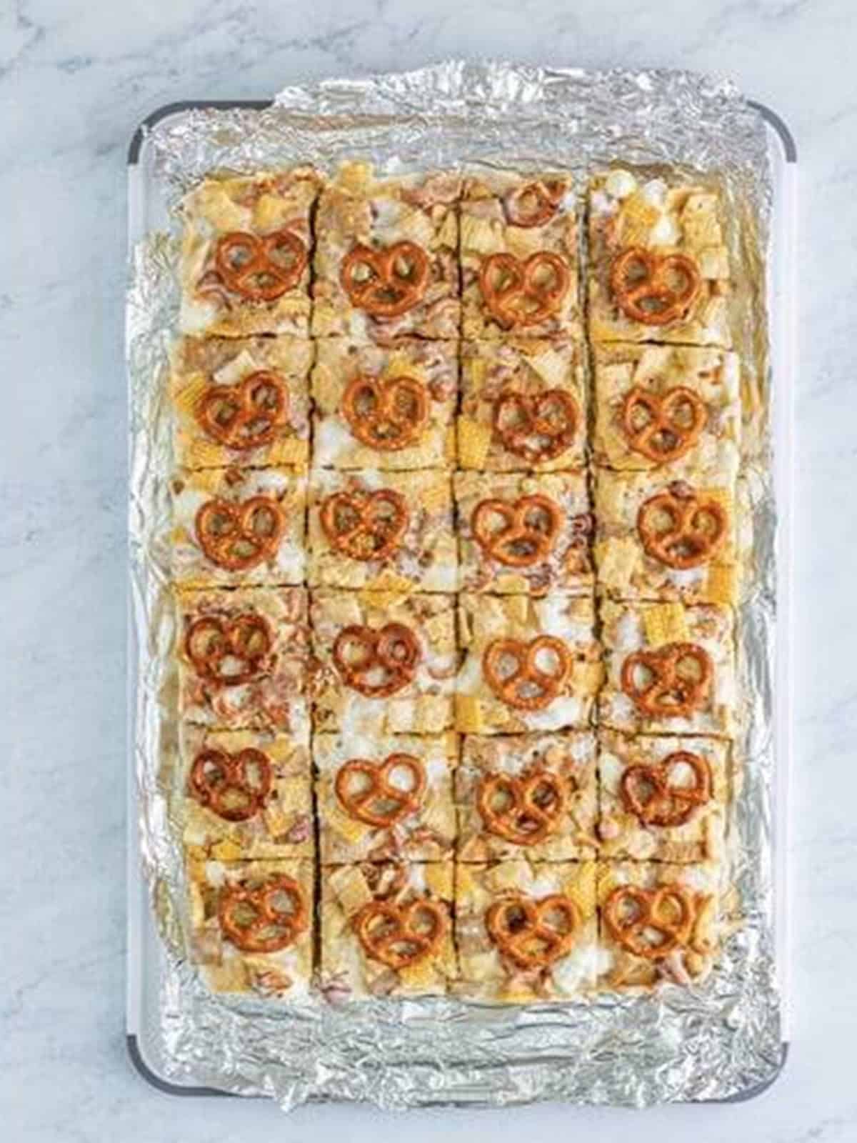 Chex Marshmallow Treats sliced into squares showing the pretzels, nuts, and cereal.