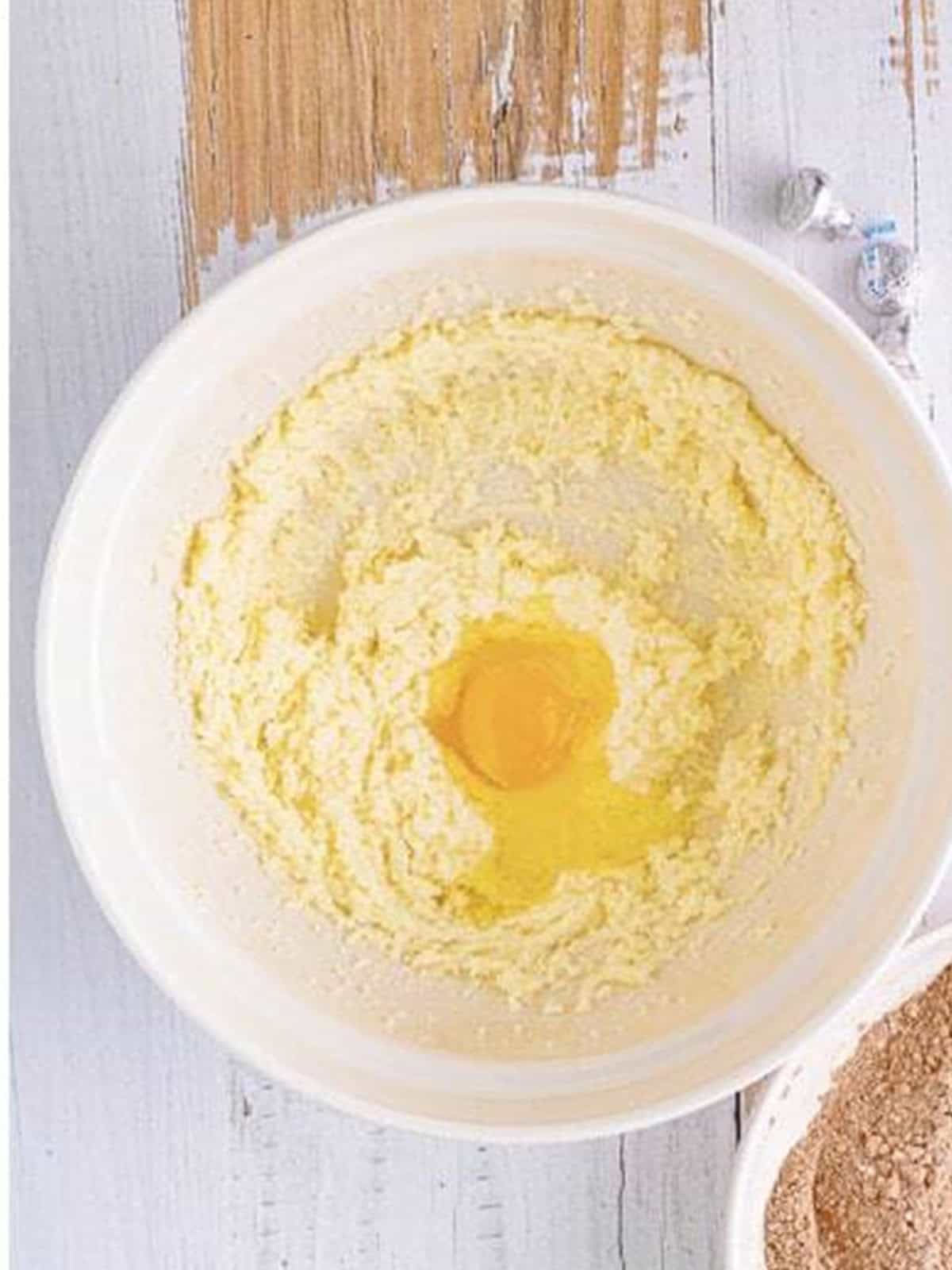 Adding the egg to the creamed butter and sugar.