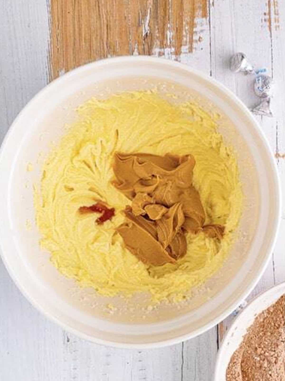 Adding creamy peanut butter and vanilla to the cookie dough base.