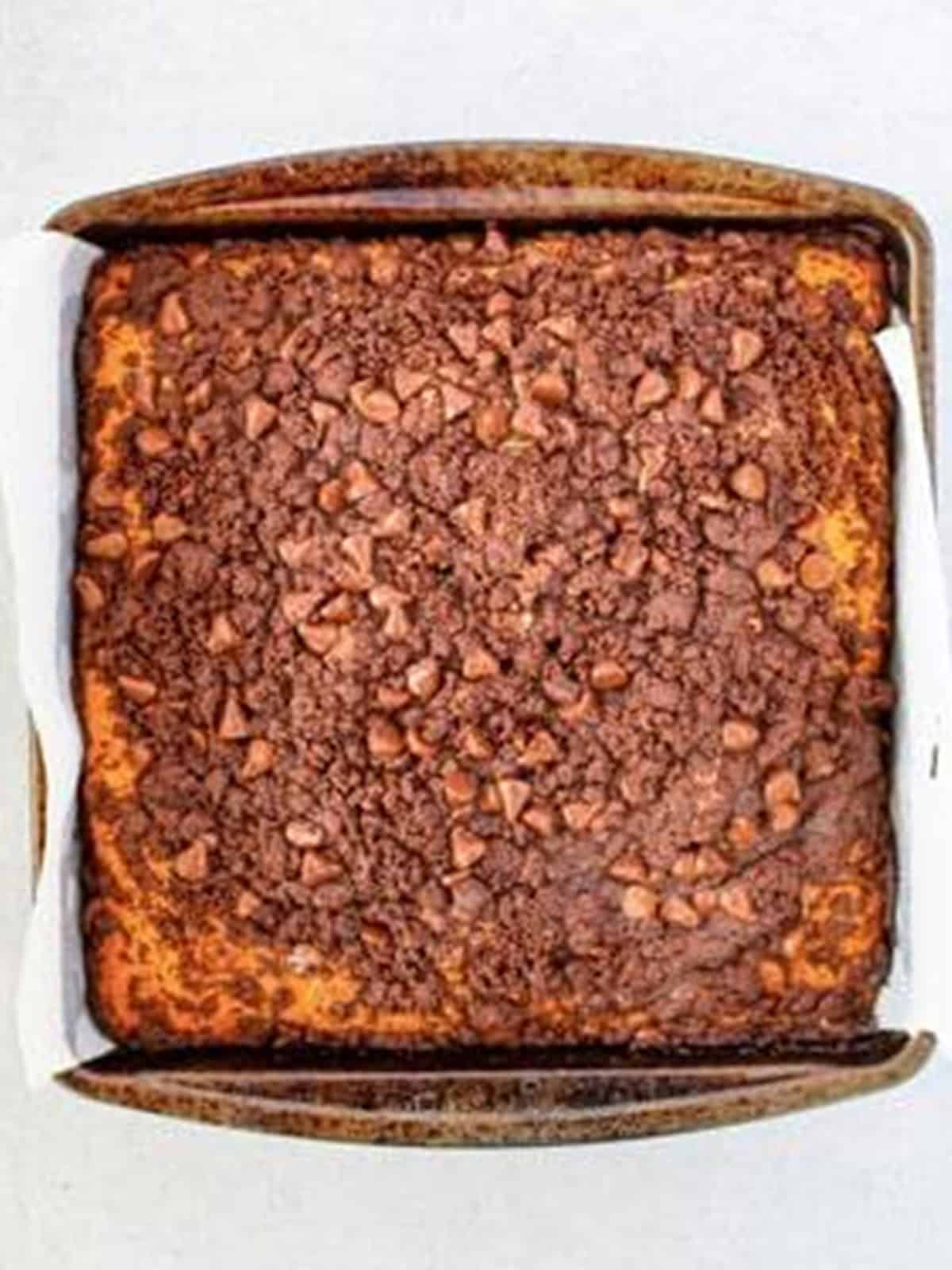 Baked Chocolate Chip Coffee Cake topped with chocolate crumble in the pan.