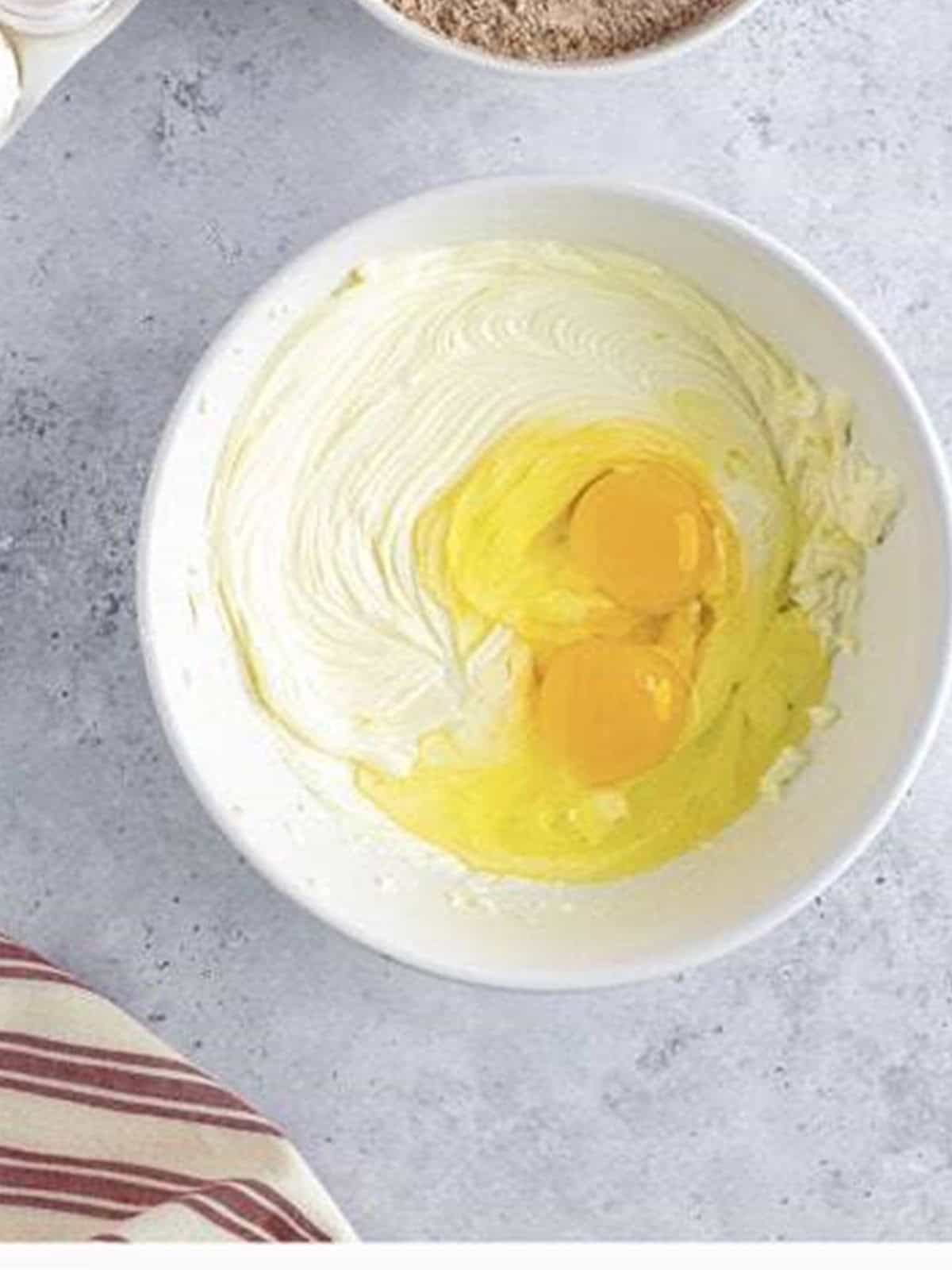 Eggs added to creamed butter for the chocolate cupcake batter.