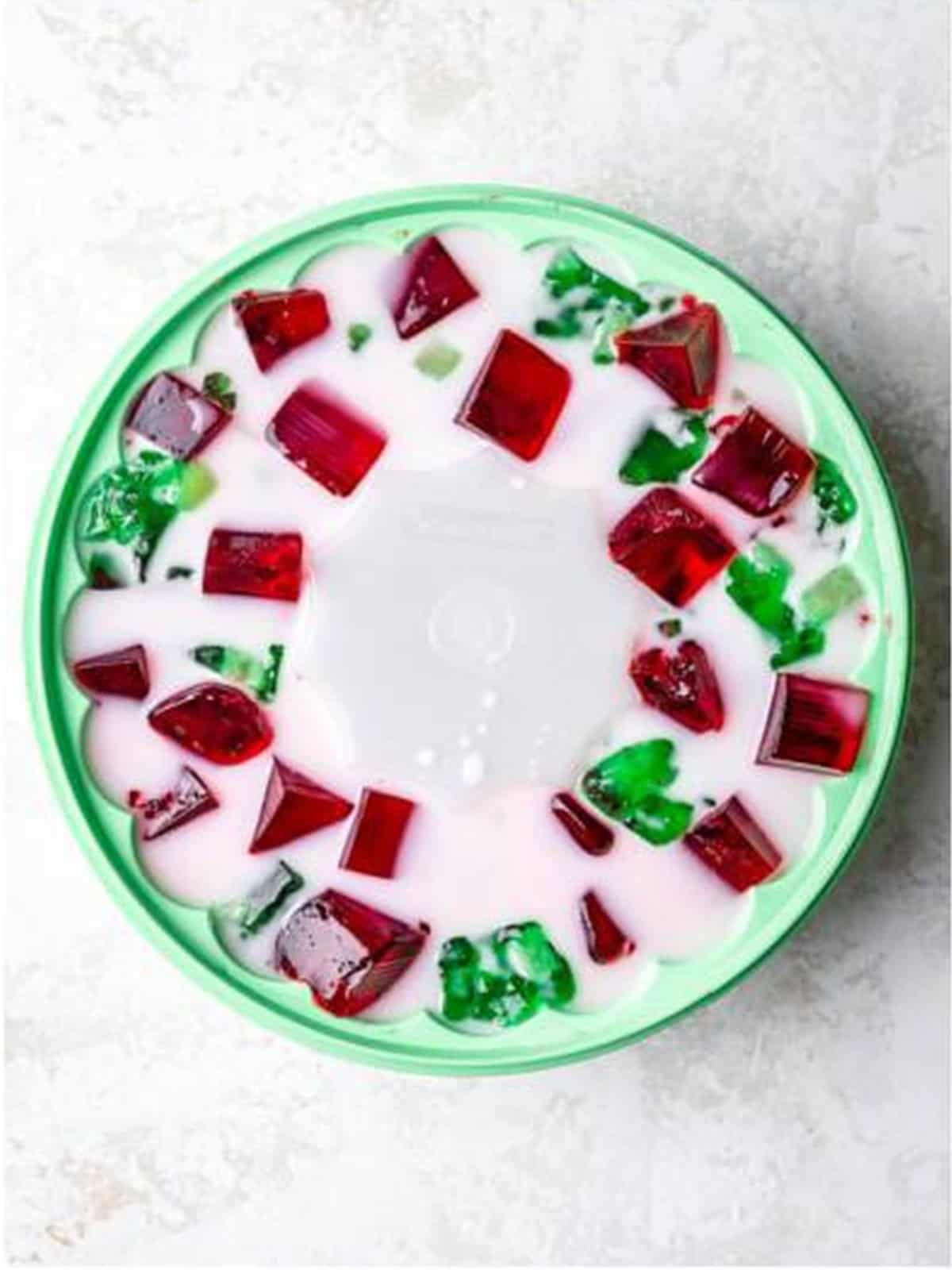 Creamy coconut layer poured over the cubed jello in a ring mold.