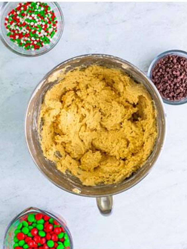 The flour mixture stirred into the christmas sandwich cookie dough.