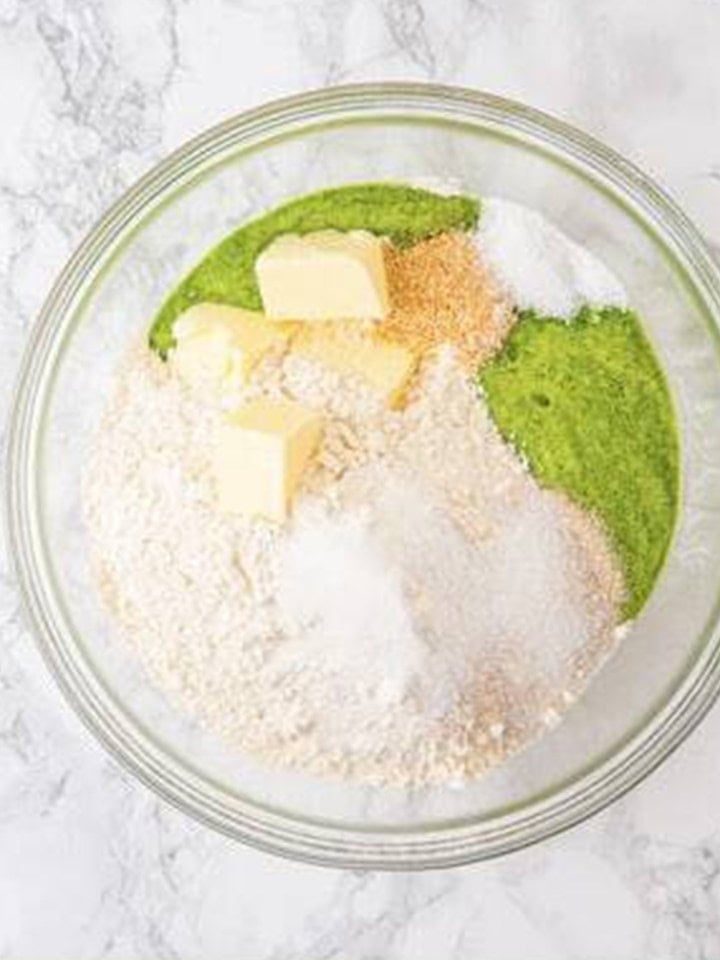 Flour, butter, yeast, sugar, and salt added to the spinach mixture for the green dough.