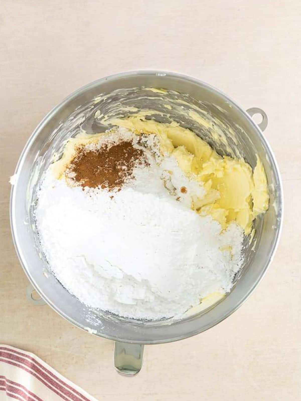 Powdered sugar, vanilla, and ground cinnamon added to the whipped cream cheese mixture.