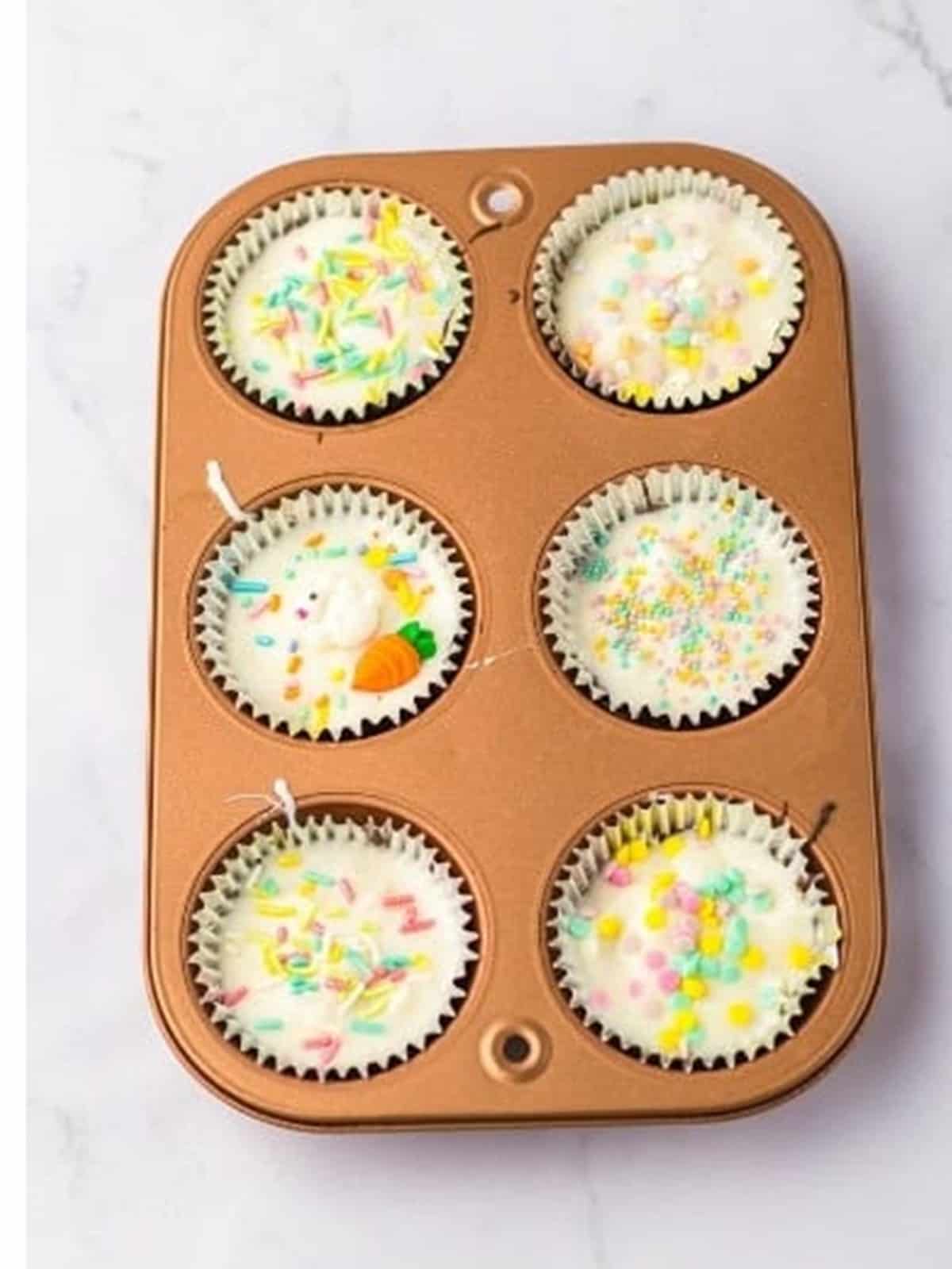 Melted white almond bark spooned over the Coconut Candy cups and topped with Easter sprinkles.