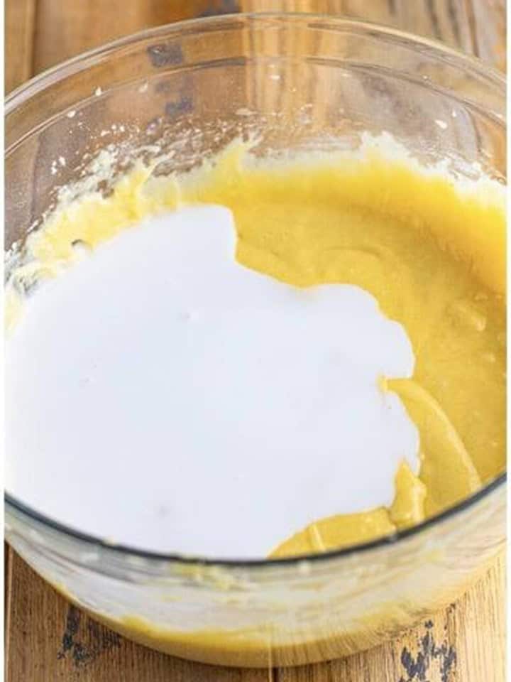 Coconut milk poured over the batter to alternate with the flour mixture.