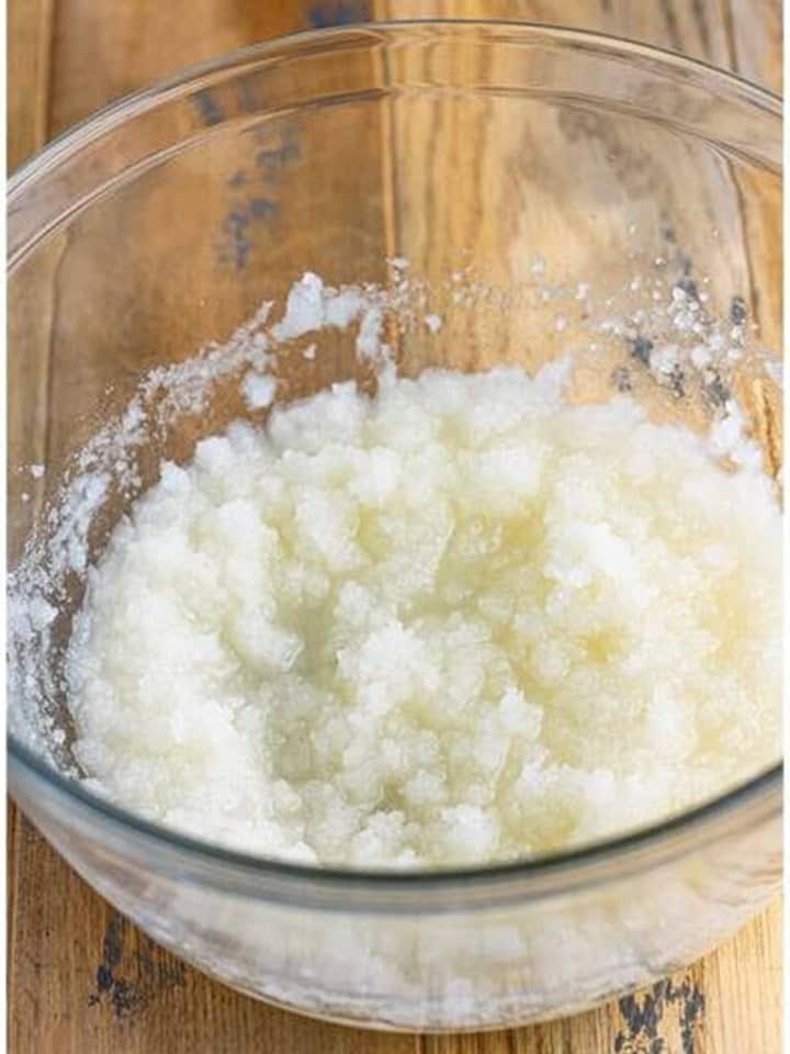 Granulated sugar and vegetable oil whisked together in a large glass bowl.