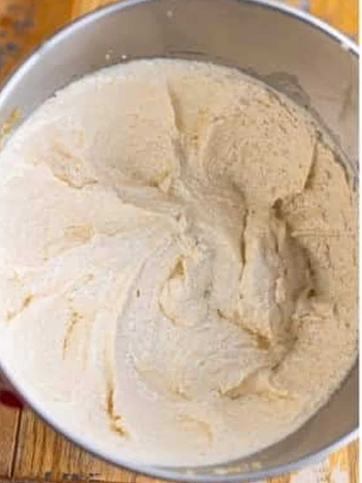 Butter, oil, and sugar creamed pale and fluffy in a stand mixer for coffee walnut cake.