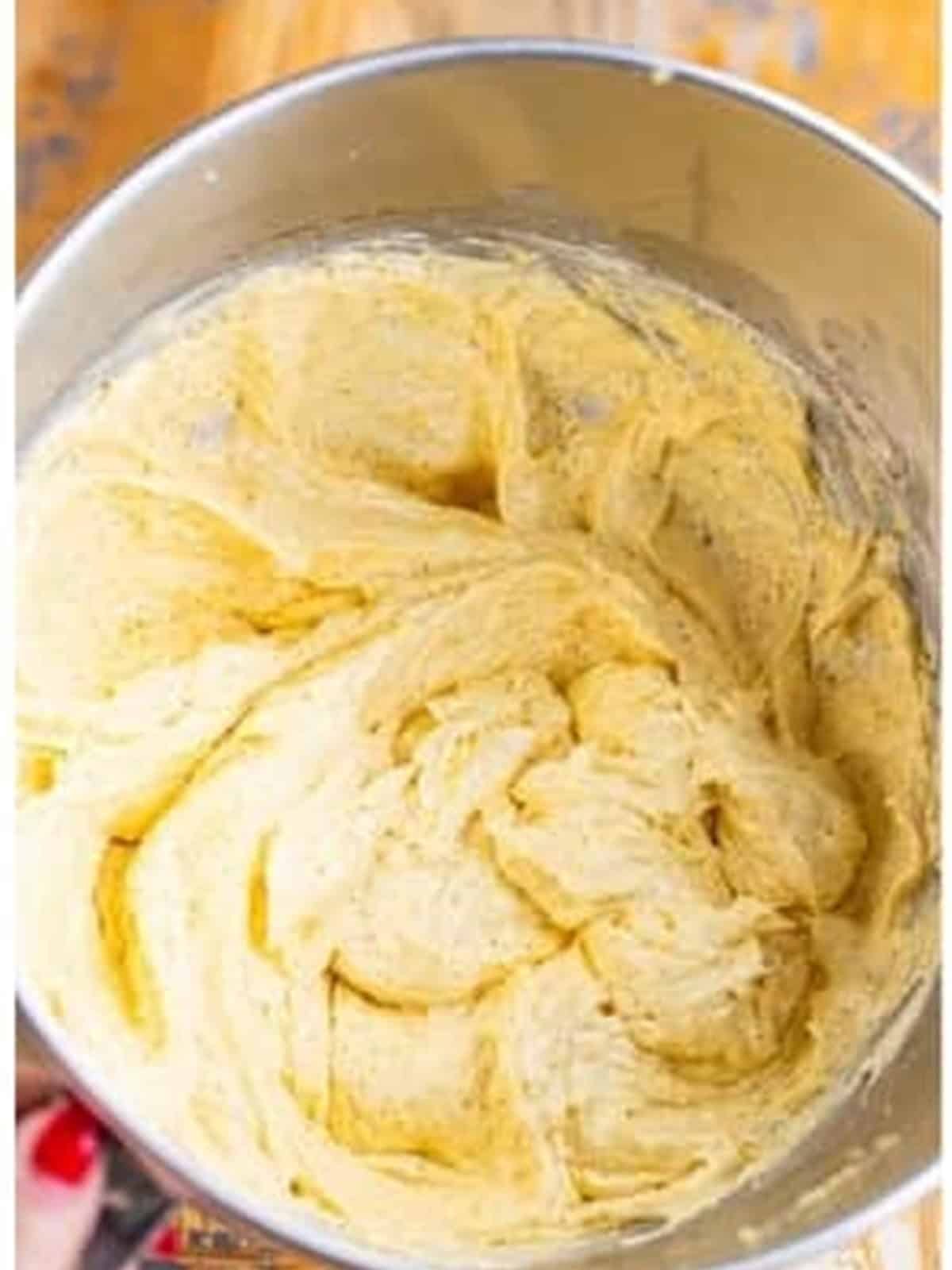 Eggs beaten into the creamed butter and sugar batter for coffee walnut cake.